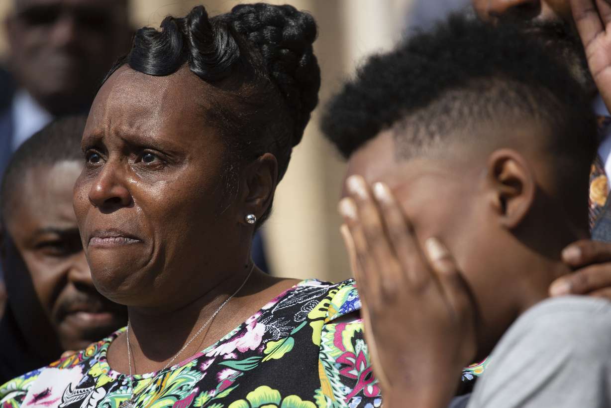 Tirzah Patterson, wife of Buffalo shooting victim Heyward Patterson, speaks as her son, Jaques “Jake” Patterson, 12, covers his face during a press conference outside of the Antioch Baptist Church on May 19.