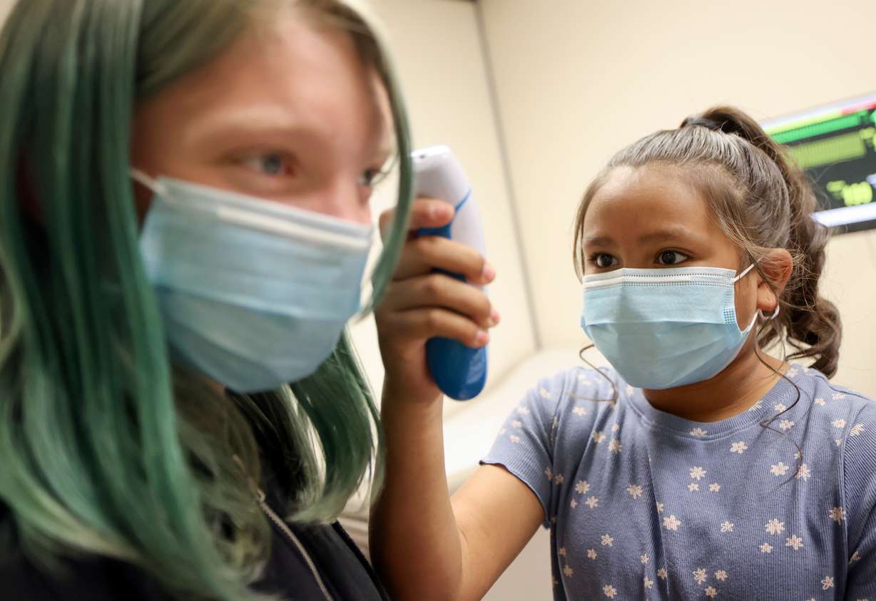 Whittier Elementary sixth grade student Layney Spencer checks the temperature of her classmate Emiry Ozmore while visiting the University of Utah College of Nursing for "Imagine U. Day" in Salt Lake City on Wednesday.