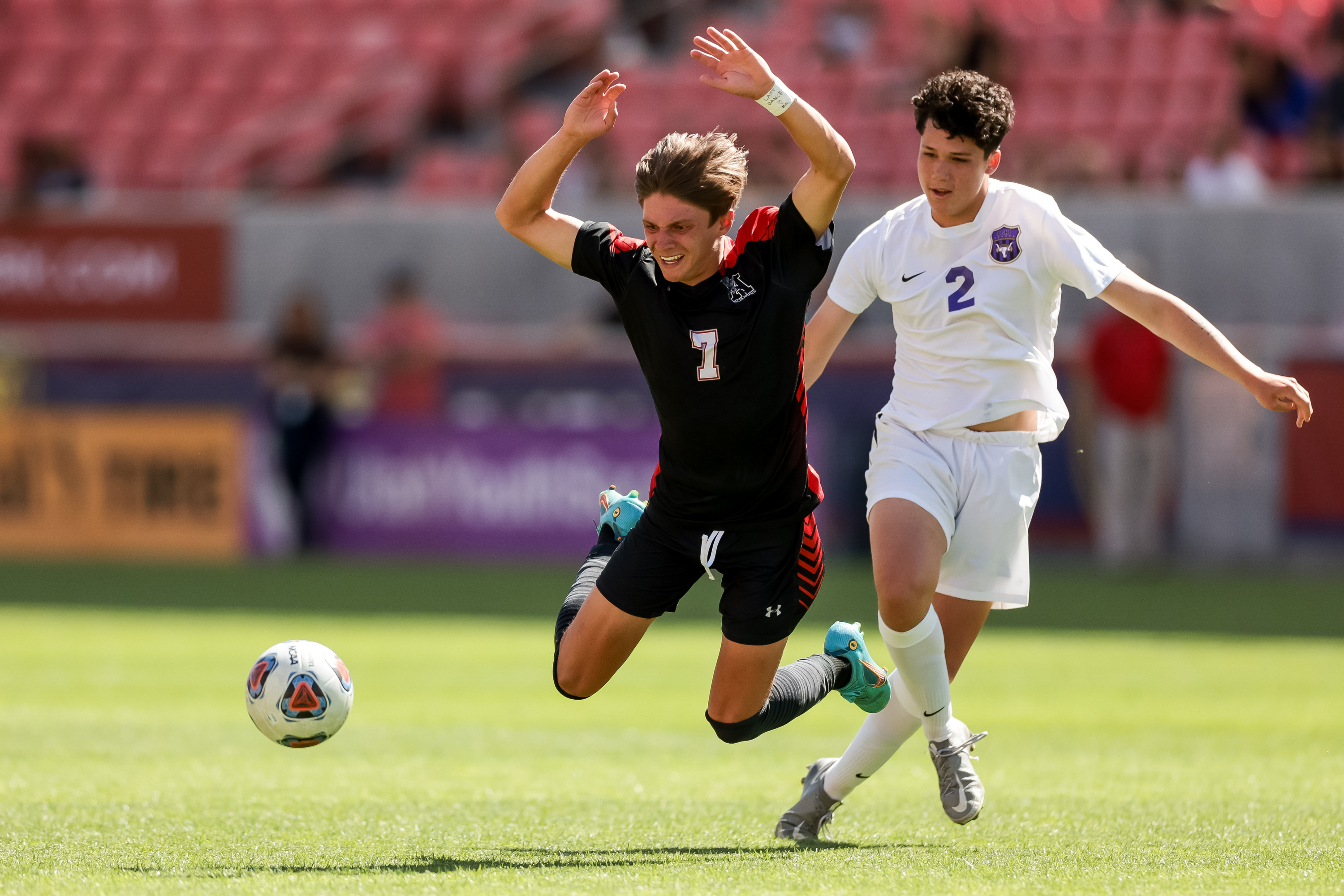 Alta’s Jack Johnson goes flying after being tripped by Lehi’s Tyson Haunga, earning Haunga a yellow card, during the 5A boys soccer state championship at Rio Tinto Stadium in Sandy on Wednesday, May 25, 2022.