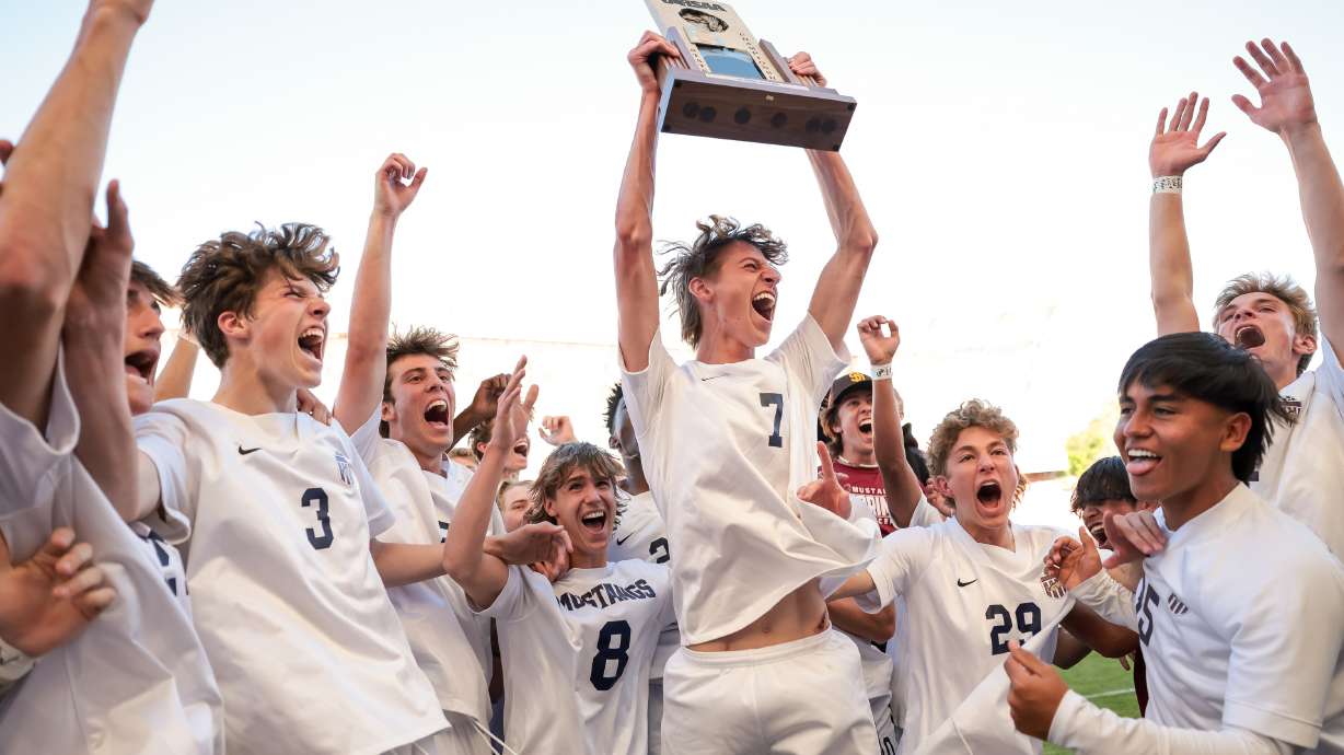 Herriman’s Trevor Walk celebrates with teammates after kicking the game-winning goal with mere seconds on the clock in the 6A boys soccer state championship against Davis at Rio Tinto Stadium in Sandy on Wednesday, May 25, 2022.