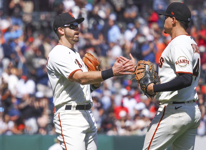 May 25, 2022; San Francisco, California, USA; San Francisco Giants third baseman Evan Longoria (10) celebrates with first baseman Wilmer Flores (41) after a win against the New York Mets at Oracle Park.