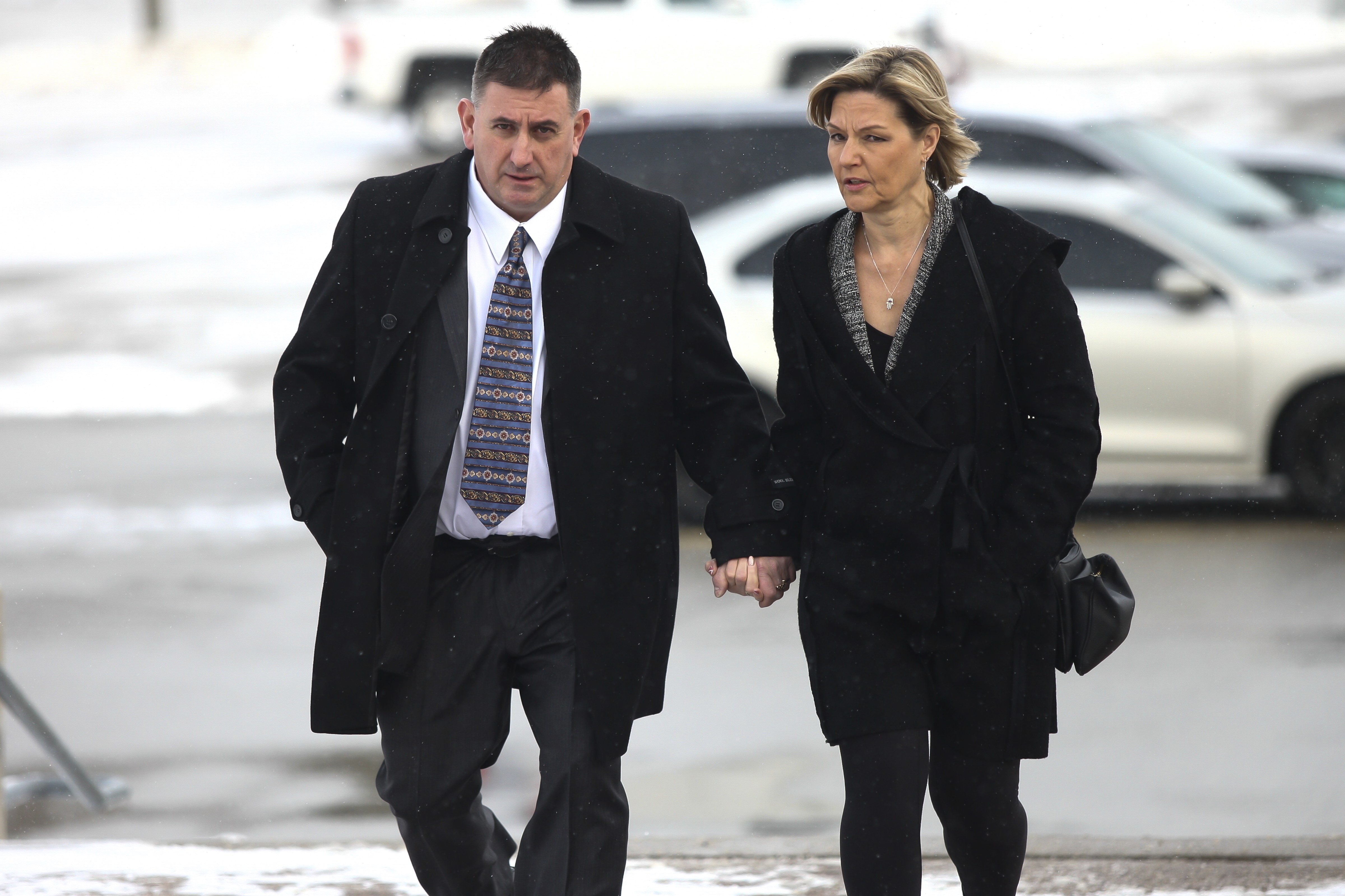 Former Canadian gymnastics coach Dave Brubaker arrives at a courthouse with his wife Elizabeth Brubaker in Sarnia, Ontario, Wednesday, Feb. 13, 2019. A former member of the Canadian national gymnastics team wrote a public letter accusing the country's 2016 Olympic coach of climbing into bed and pressing his body up against her, reaching his hand underneath her shirt and trying to talk her into exposing her breasts. The letter by Abby Pearson Spadafora, 38, revealed the latest in a long series of allegations of sexual, emotional and physical abuse by coaches Dave and Elizabeth Brubaker, who have been banned by Gymnastics Canada. 