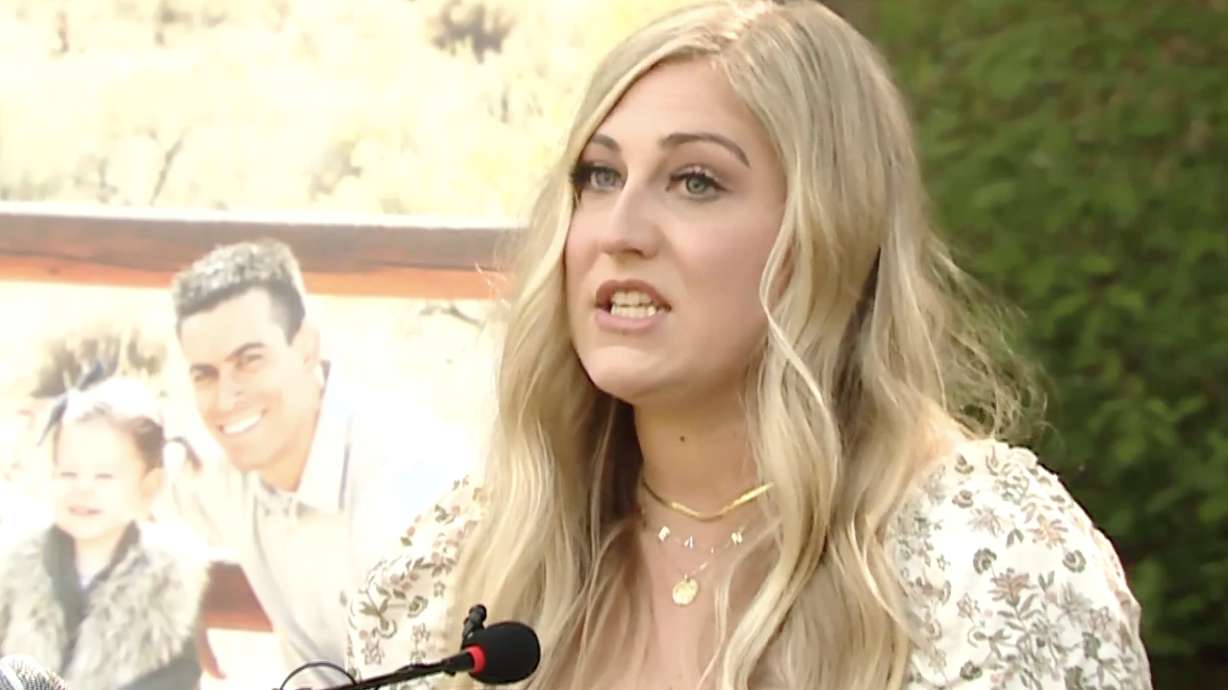 Jordin Petersen Seamons stands in front of a photo of her husband, Devin, who died in a 2018 car crash during a press briefing Thursday at Memory Grove in Salt Lake City.