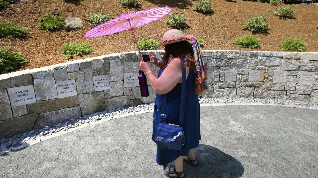Karla Hailer, a fifth-grade teacher from Scituate, Mass., stands at the site in Salem, Mass., on July 19, 2017, where five women were hanged as witches more than three centuries years earlier. Massachusetts lawmakers on Thursday formally exonerated Elizabeth Johnson Jr., clearing her name 329 years after she was convicted of witchcraft.