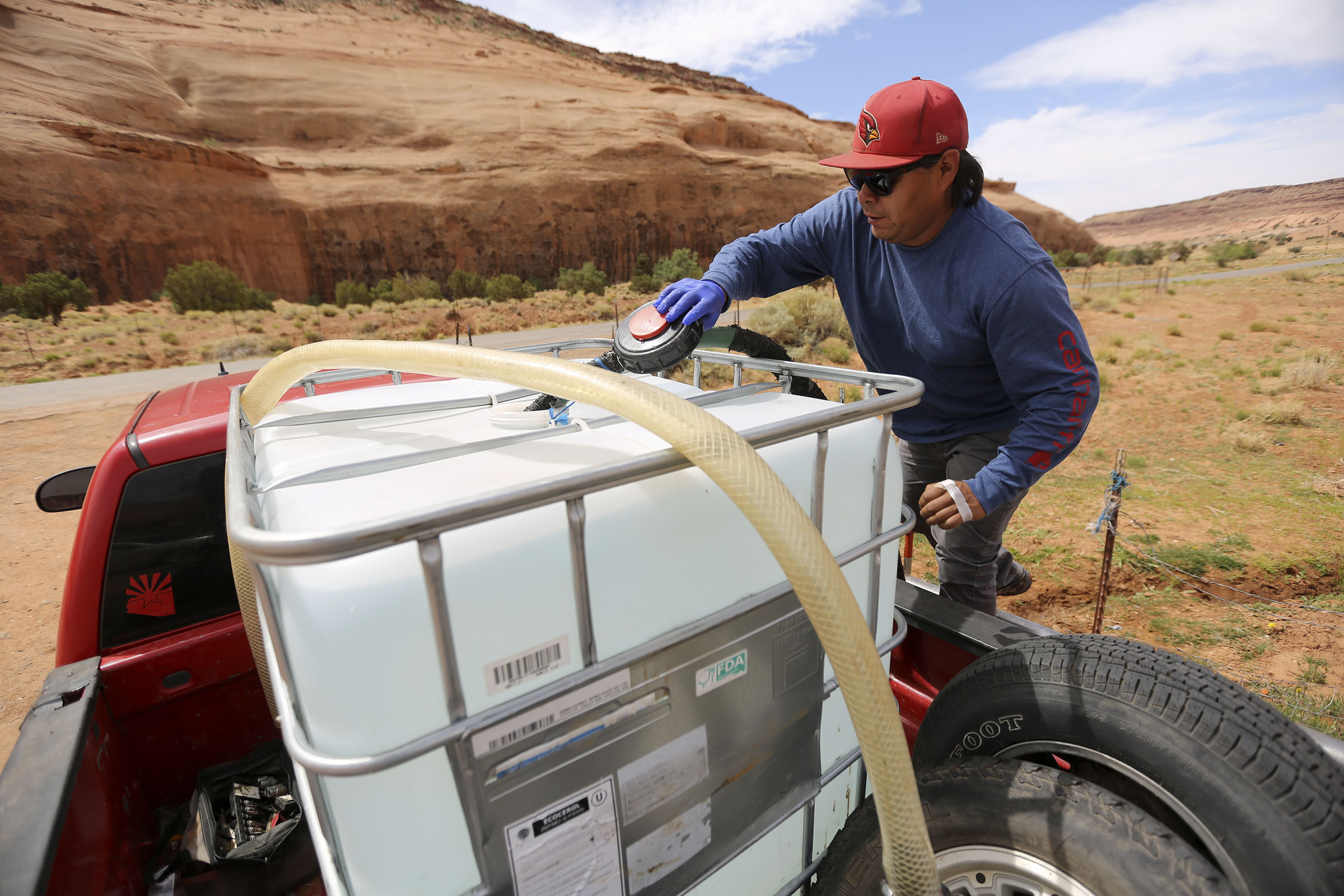 Will Yazzie fills a 250-gallon water tank in Oljato-Monument Valley, San Juan County on April 30, 2020. A historic agreement sets aside what was destined to be a protracted legal battle between the Navajo Nation and the state of Utah over rights to water in the Colorado River.
