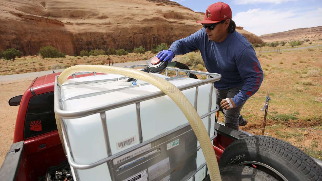 Will Yazzie fills a 250-gallon water tank in Oljato-Monument Valley, San Juan County on April 30, 2020. A historic agreement sets aside what was destined to be a protracted legal battle between the Navajo Nation and the state of Utah over rights to water in the Colorado River.