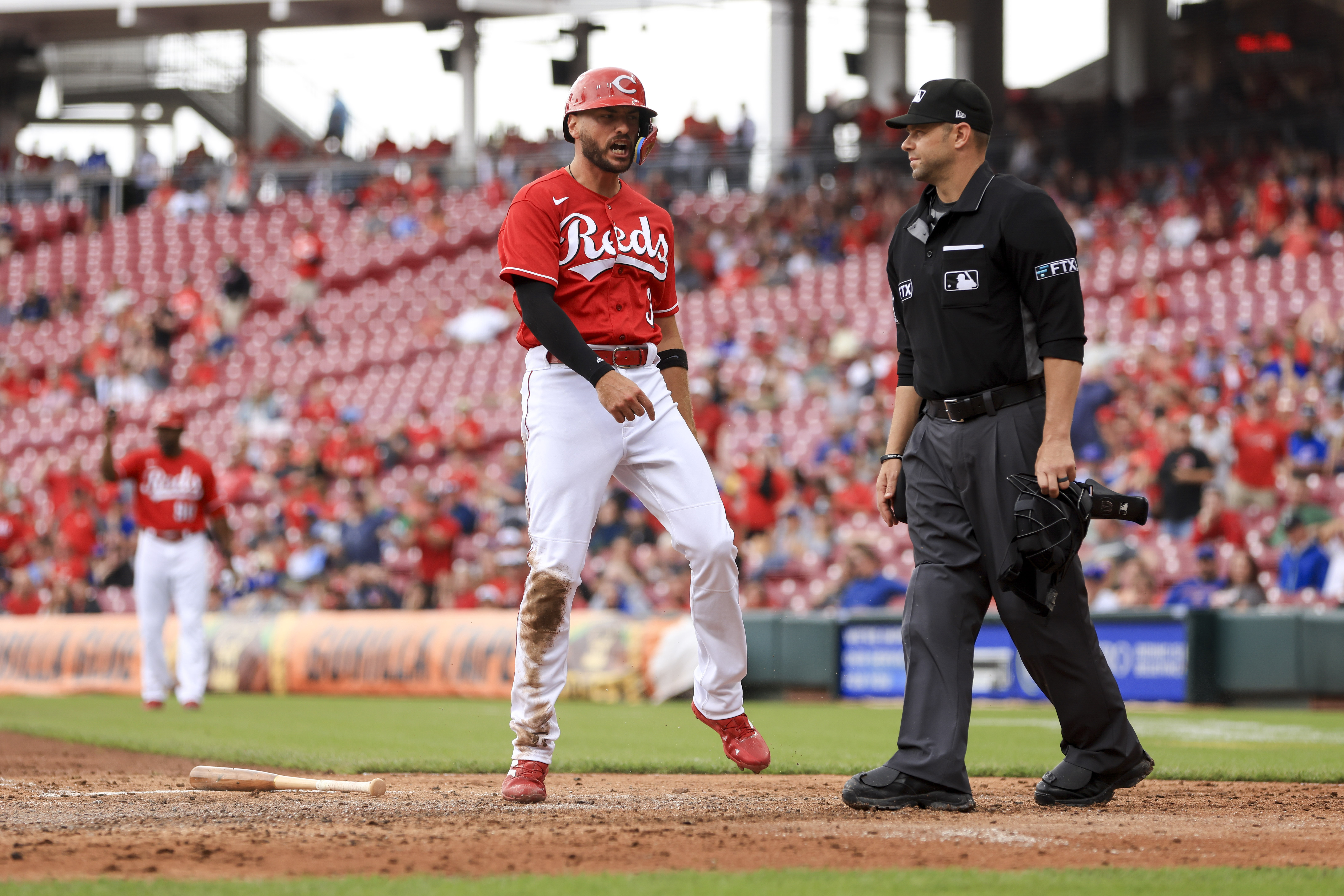 Cincinnati Reds' Albert Almora Jr. yells as he scores a run on a triple by Mark Reynolds during the third inning of a baseball game against the Chicago Cubs in Cincinnati, Thursday, May 26, 2022. 