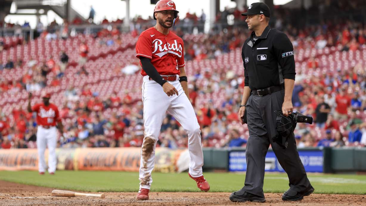 Cincinnati Reds' Albert Almora Jr. yells as he scores a run on a triple by Mark Reynolds during the third inning of a baseball game against the Chicago Cubs in Cincinnati, Thursday, May 26, 2022.