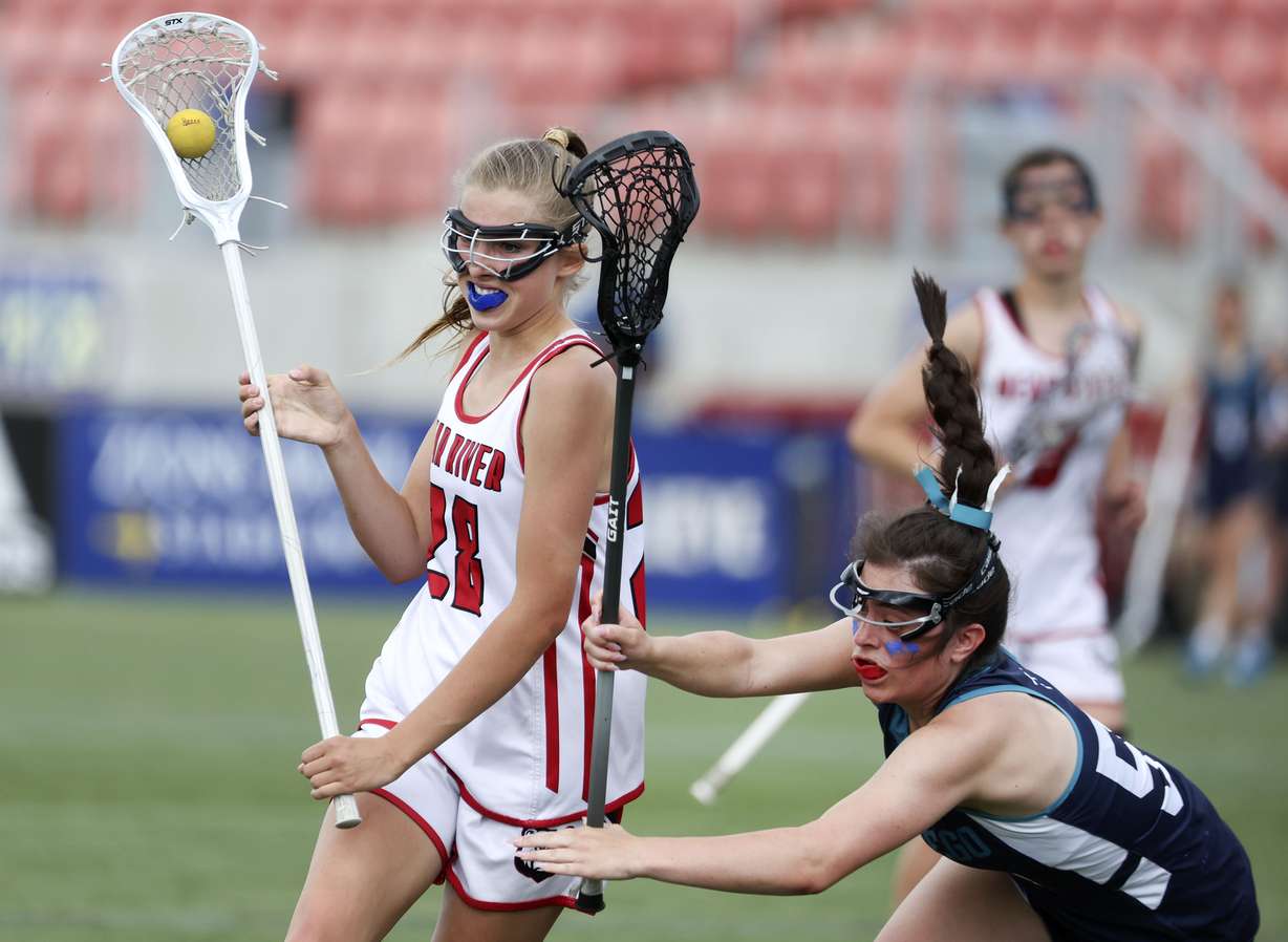 Bear River’s Makenzie Mickelsen keeps the ball from Juan Diego’s Nola Christensen in the 4A girls lacrosse state championship game at Zions Bank Stadium in Herriman on Thursday, May 26, 2022.