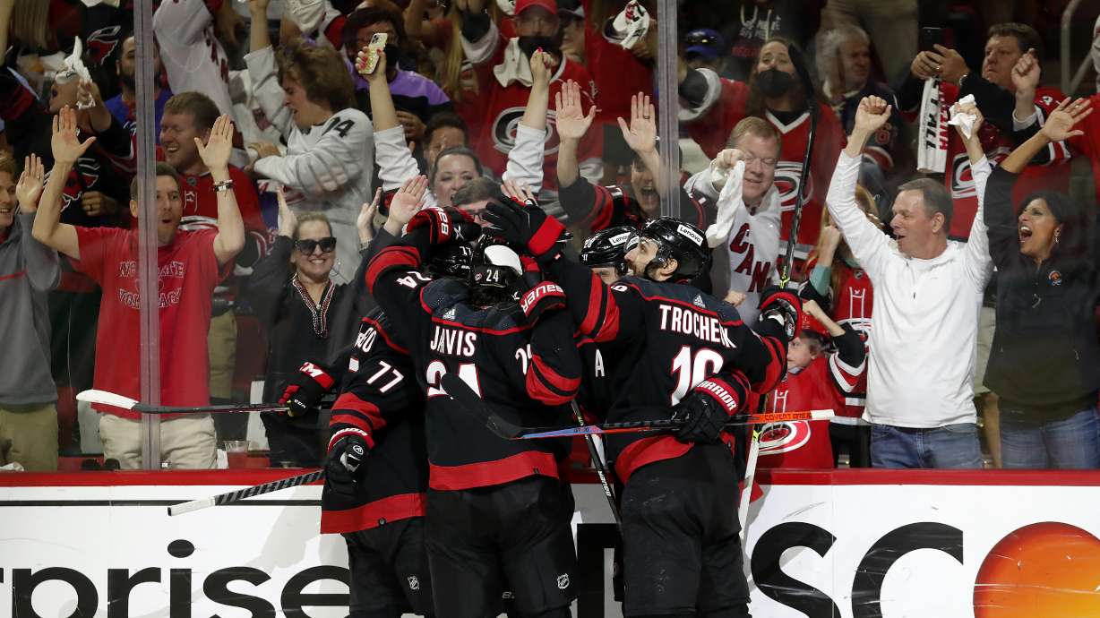 The Carolina Hurricanes celebrate a goal by Teuvo Teravainen against the New York Rangers during the second period of Game 5 of an NHL hockey Stanley Cup second-round playoff series in Raleigh, N.C., Thursday, May 26, 2022.