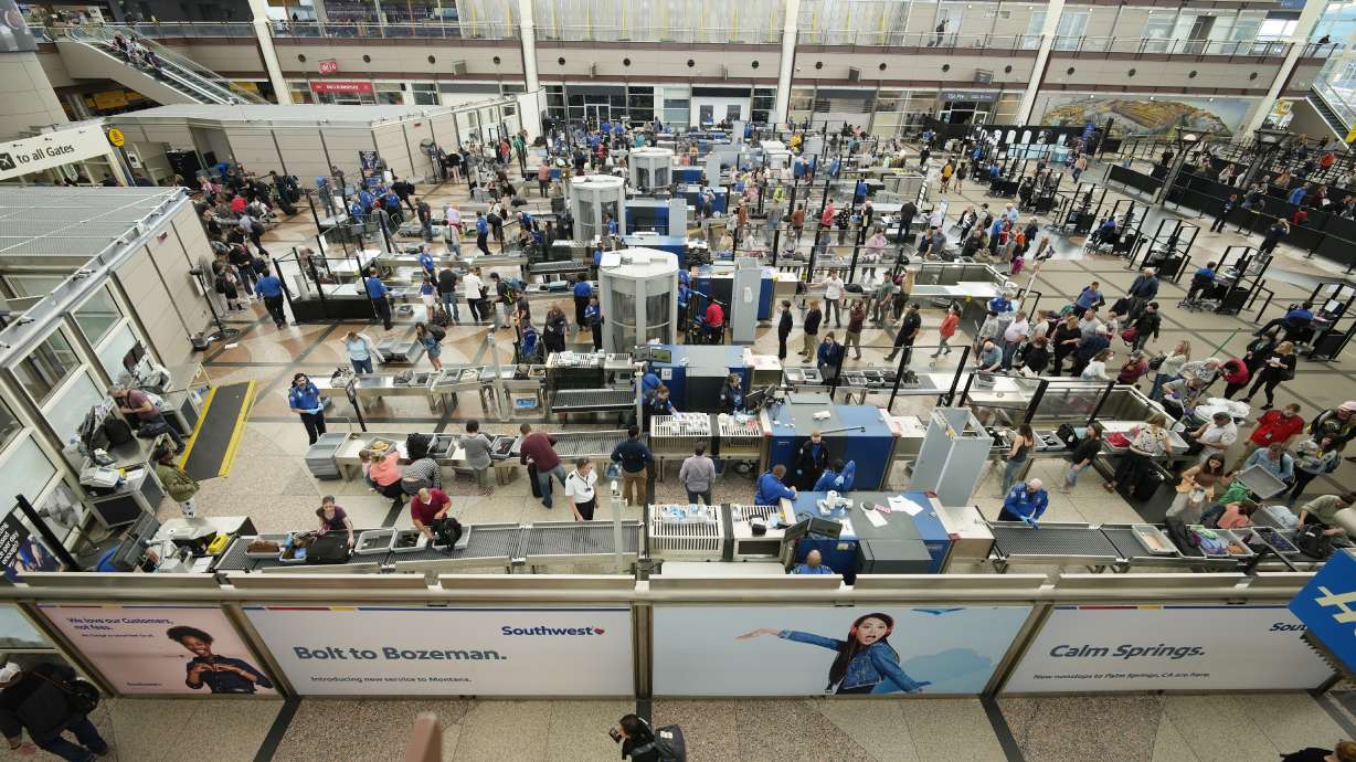 Travelers queue up at the south security checkpoint in the main terminal of Denver International Airport, Thursday in Denver. Experts are expecting a flush of travelers at airports and on the nation's byways during the long Memorial Day weekend, which marks the start of the summer travel season, in spite of high fuel costs.