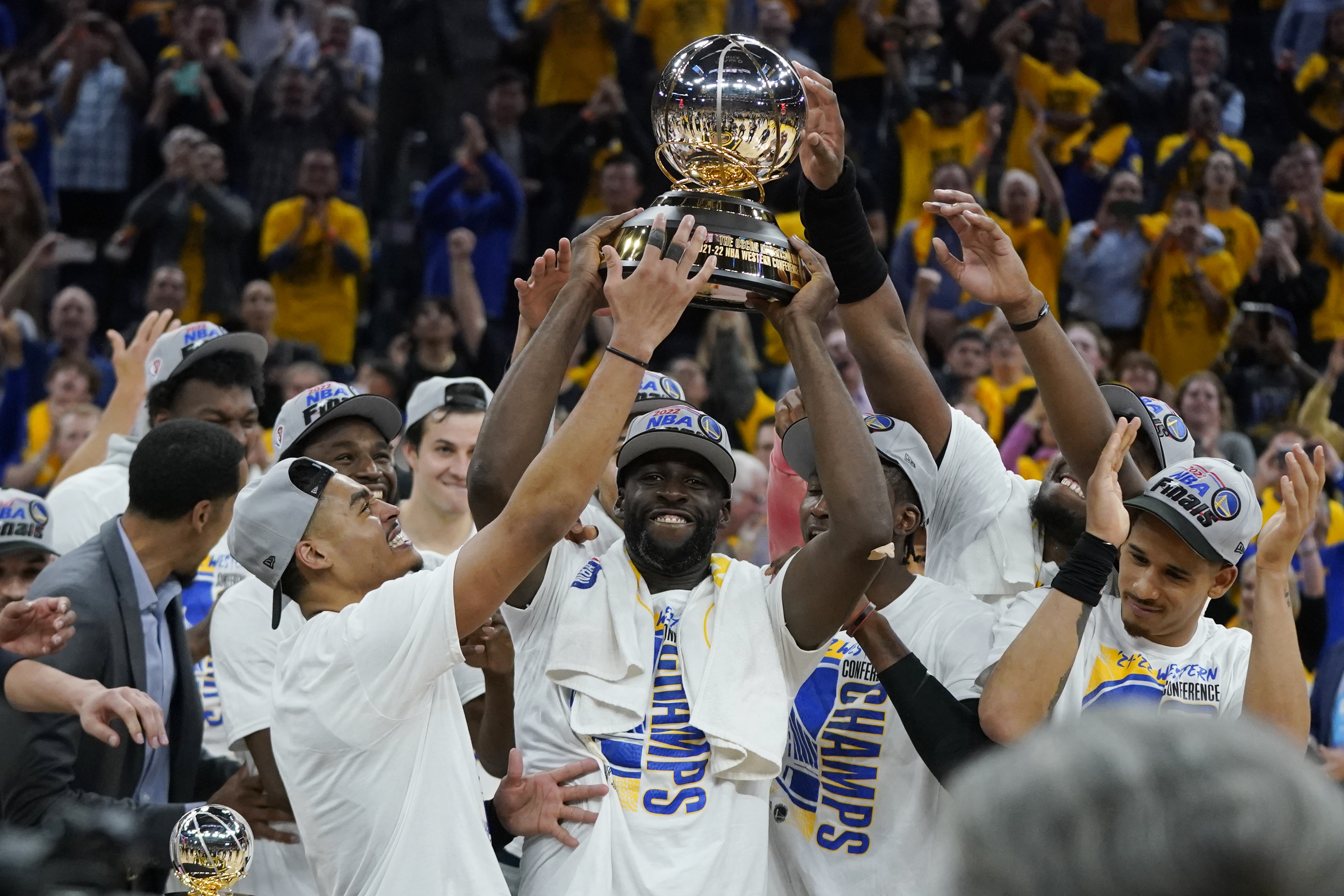 Golden State Warriors celebrate with the conference trophy after defeating the Dallas Mavericks in Game 5 of the NBA basketball playoffs Western Conference finals in San Francisco, Thursday, May 26, 2022. 