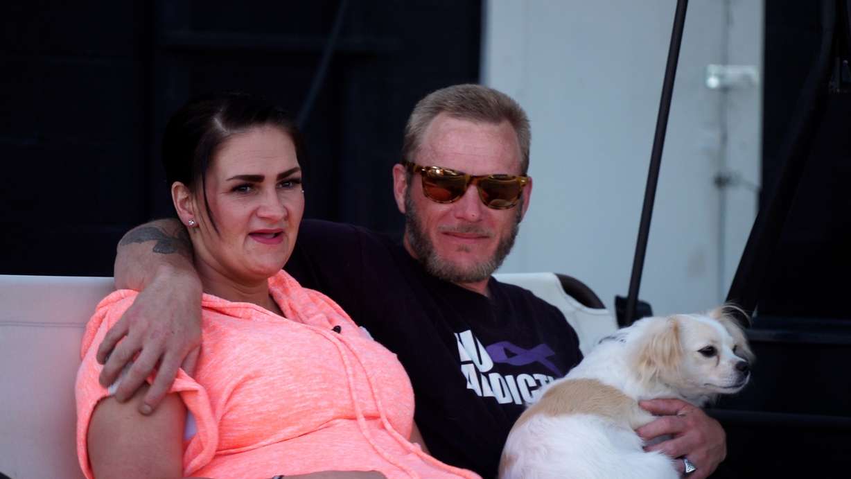 Tiffani Fergeson and Rhett Bargar relax on a porch swing at their home in Clearfield with their dog, Tulip.