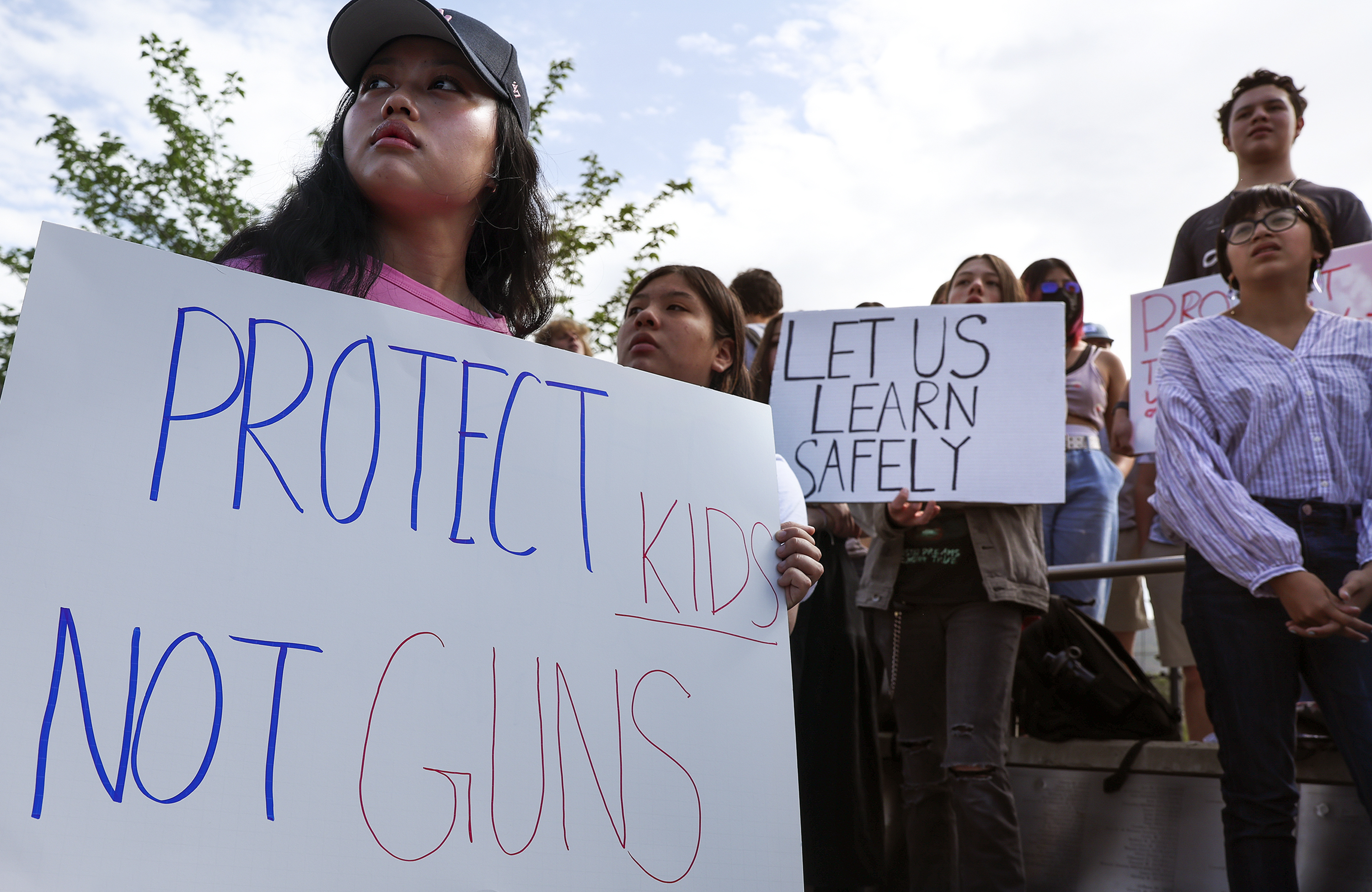 East High School student Jennifer Kyizom, left, attends a walkout at the school in Salt Lake City on Friday to protest gun violence. Hundreds of students participated in the walkout just days after an 18-year-old gunman barricaded himself in a classroom at Robb Elementary School in Uvalde, Texas, and shot and killed 19 students and two teachers.