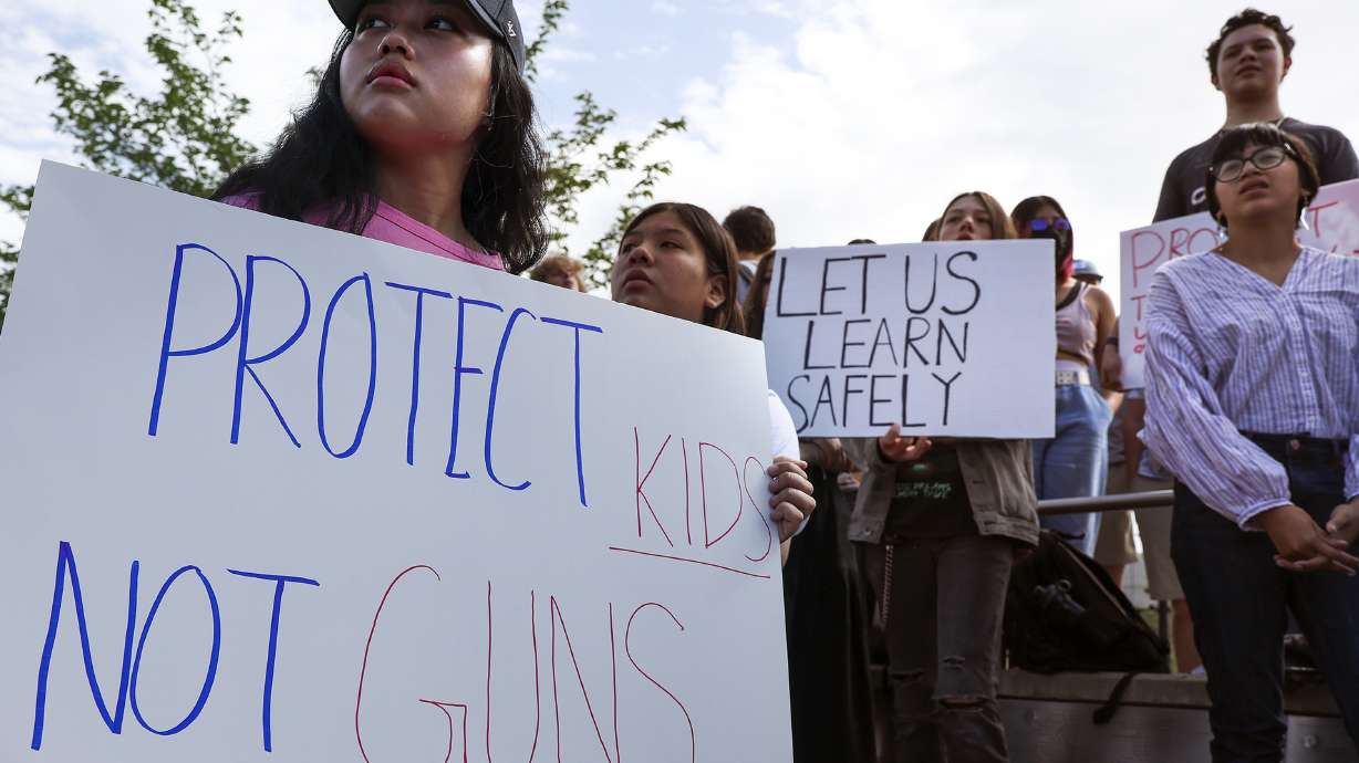 East High School student Jennifer Kyizom, left, attends a walkout at the school in Salt Lake City on Friday to protest gun violence. Hundreds of students participated in the walkout just days after an 18-year-old gunman barricaded himself in a classroom at Robb Elementary School in Uvalde, Texas, and shot and killed 19 students and two teachers.