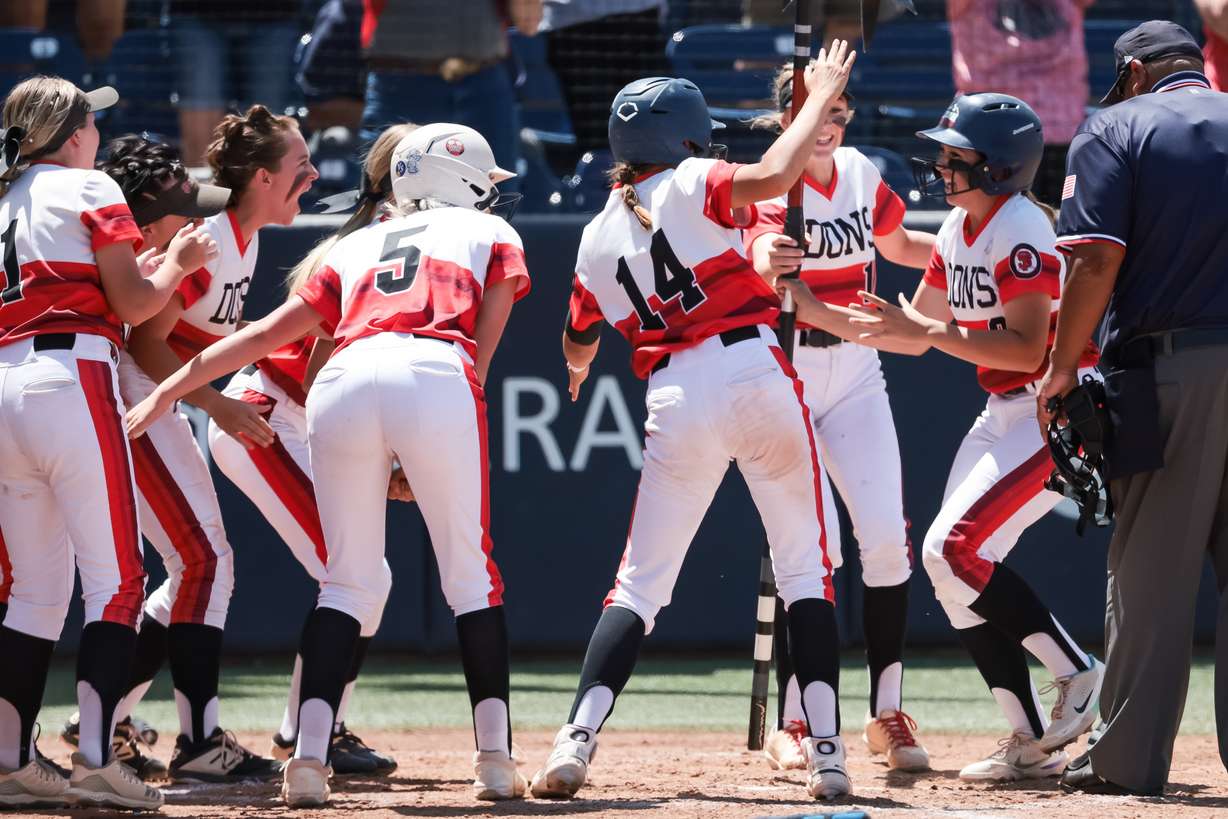 Spanish Fork’s Tatum Hall crosses home plate on a three-run home run in the 5A softball state championship against Lehi at Miller Park in Provo on Friday, May 27, 2022. One run was not counted after umpires made an “assisting the runner” call due to contact with the third base coach.