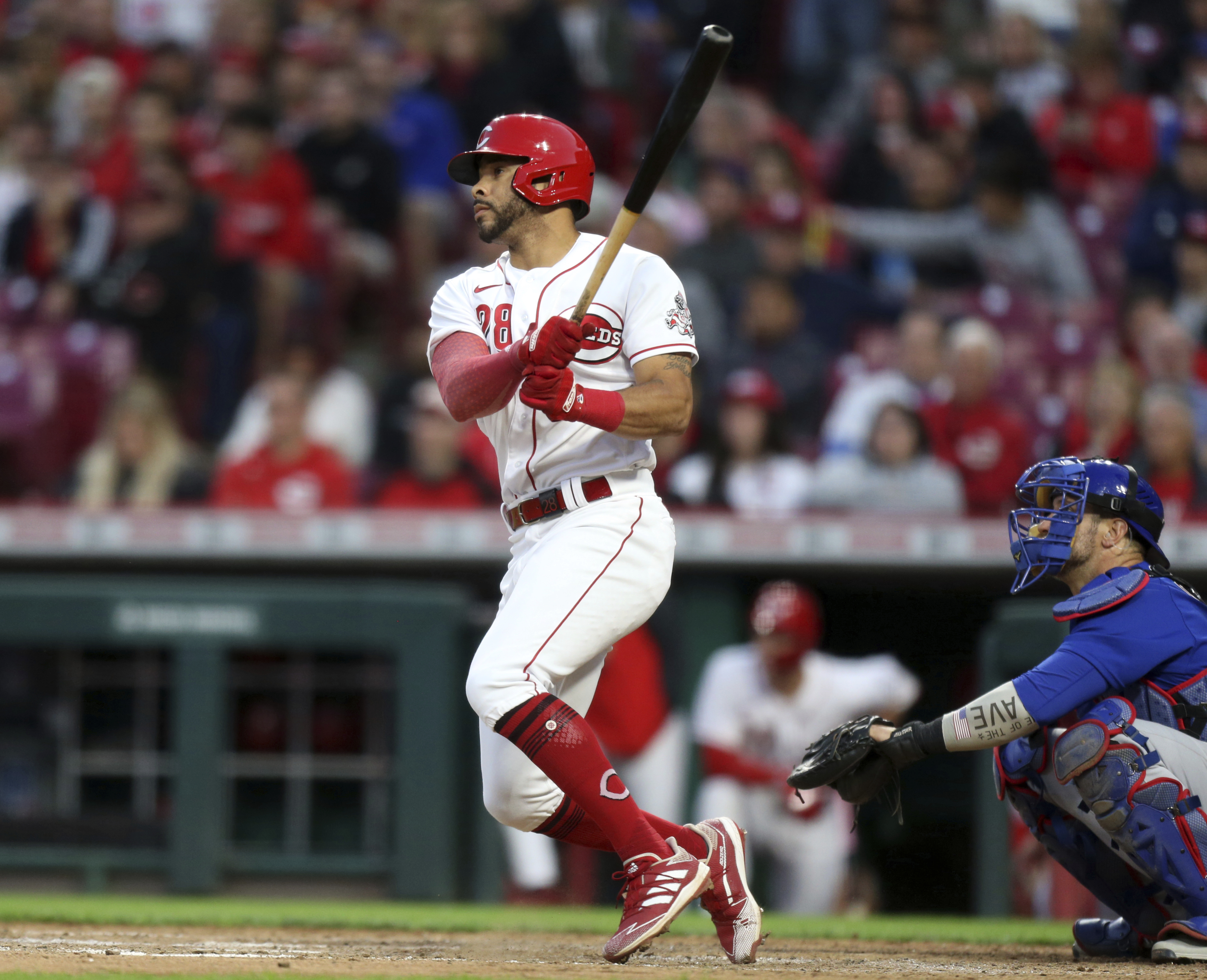 Cincinnati Reds' Tommy Pham, left, watches his home run in front of Chicago Cubs catcher Yan Gomes during the sixth inning of a baseball game in Cincinnati, Monday, May 23, 2022. 