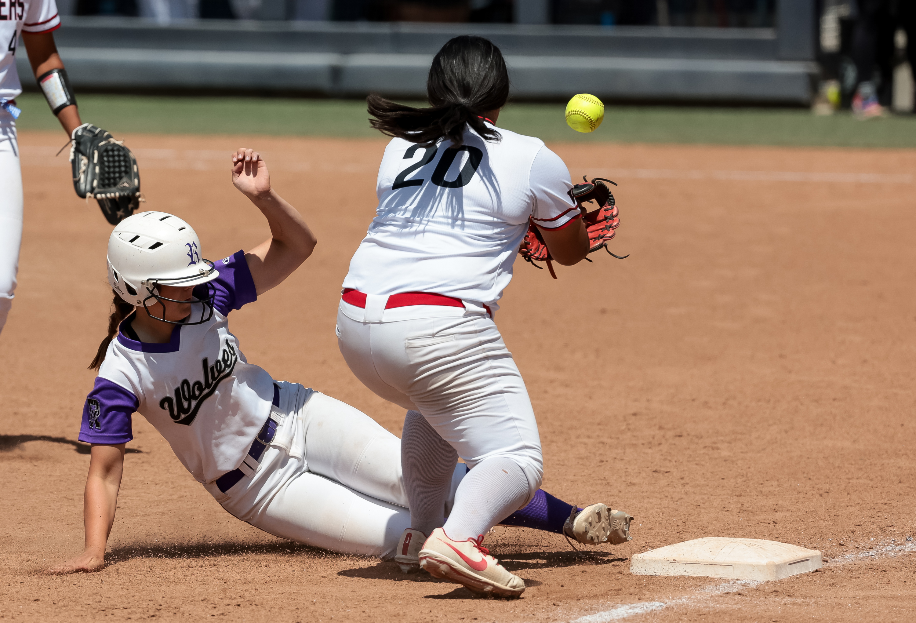 Riverton’s Kyli Carrell slides safely into third, covered by West’s Andrea Tagovailoa, in the 6A softball state championship at Miller Park in Provo on Friday, May 27, 2022.