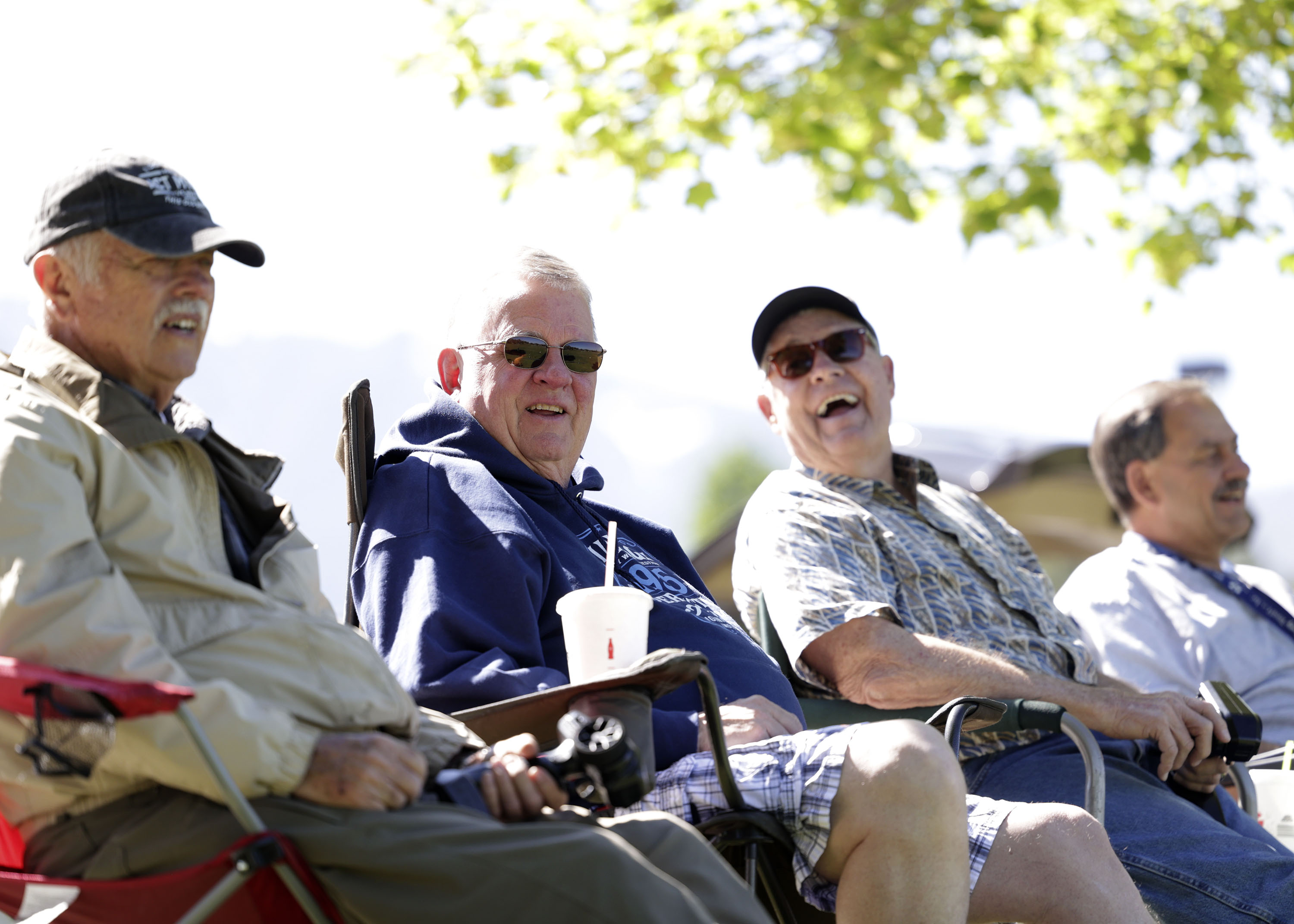 The Falcon Park Flyers laugh and talk while driving and flying their remote controlled cars and airplanes at Falcon Park in Sandy on Wednesday.