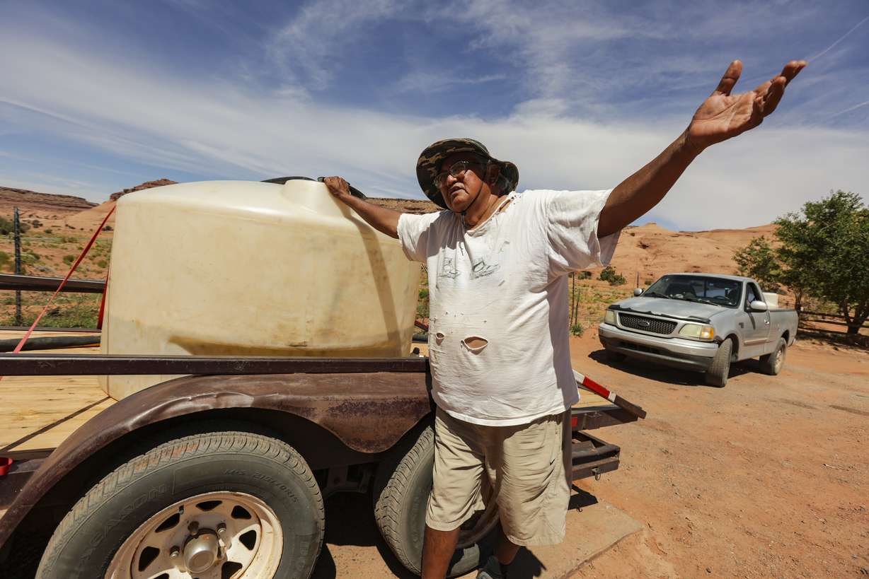 Ron Atine waits to get water at a well in Goulding, San Juan County, on Friday. Atine waited for over an hour to get the water. On Friday, U.S. Secretary of the Interior Deb Haaland and Utah Gov. Spencer J. Cox joined Jonathan Nez, the president of the Navajo Nation, and Doreen McPaul, the Navajo Nation attorney general, to sign a federal reserved water rights settlement agreement.