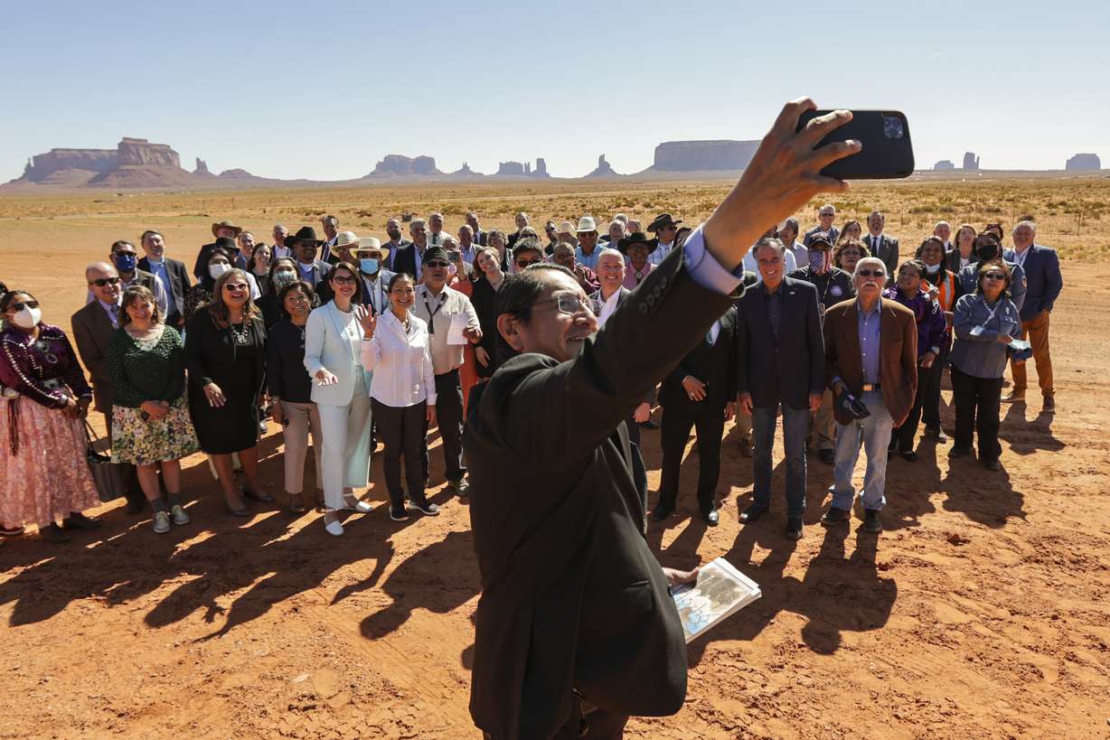 Navajo Nation President Jonathan Nez, front, takes a selfie along with Lt. Gov. Deidre Henderson, U.S. Interior Secretary Deb Haaland, Gov. Spencer Cox, Sen. Mitt Romney, R-Utah, and Navajo community members at the Navajo Welcome Center in Oljato-Monument Valley, San Juan County, on Friday.