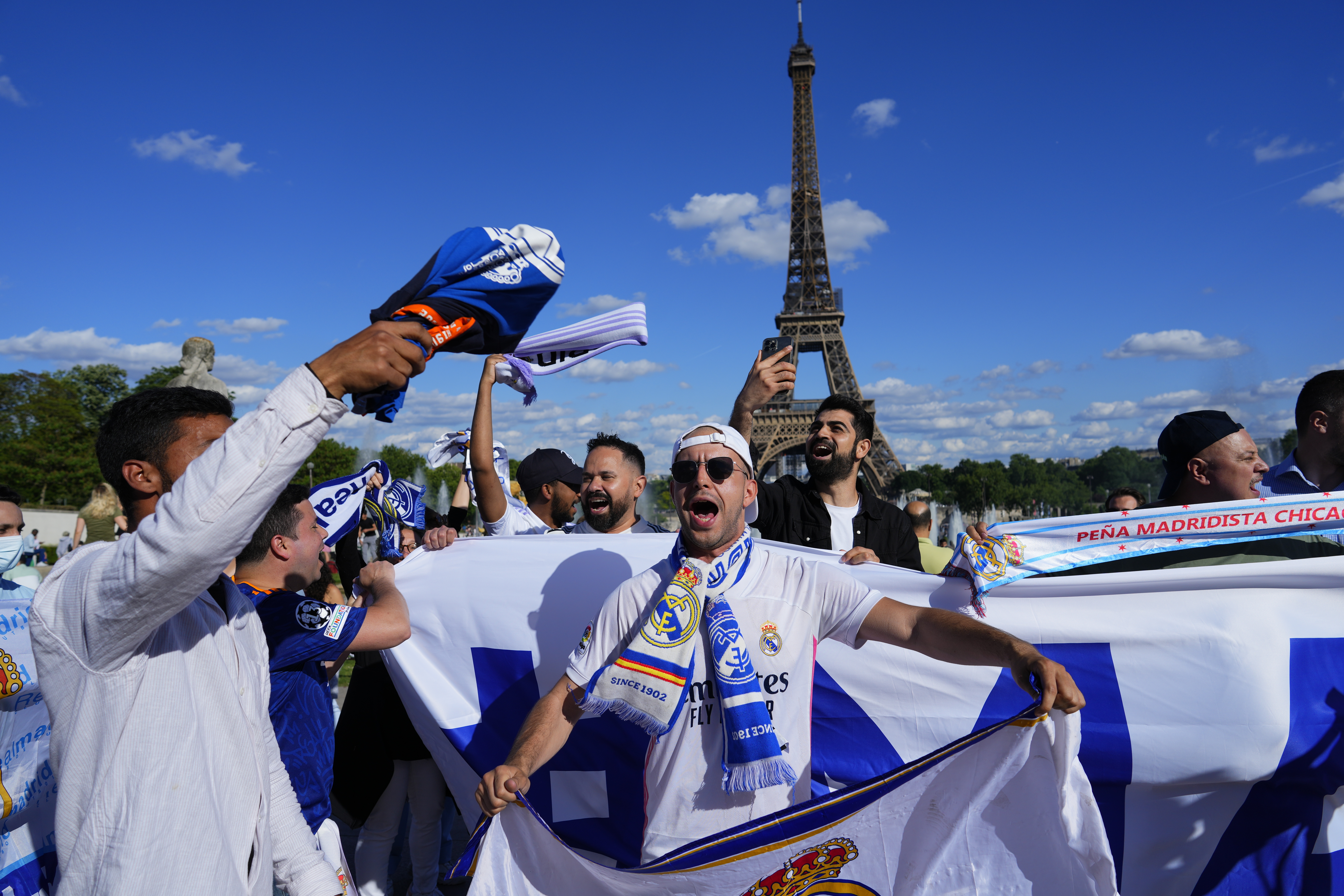 Real Madrid fans cheer in front of the Eiffel Tower Paris, Friday, May 27, 2022. Liverpool and Real Madrid will face each other in the Champions League final soccer match on Saturday. 