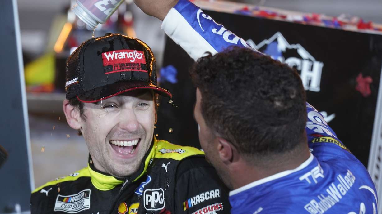 Bubba Wallace, right, pours a drink on Ryan Blaney in Victory Lane after Blaney won the NASCAR All-Star auto race at Texas Motor Speedway in Fort Worth, Texas, Sunday, May 22, 2022.