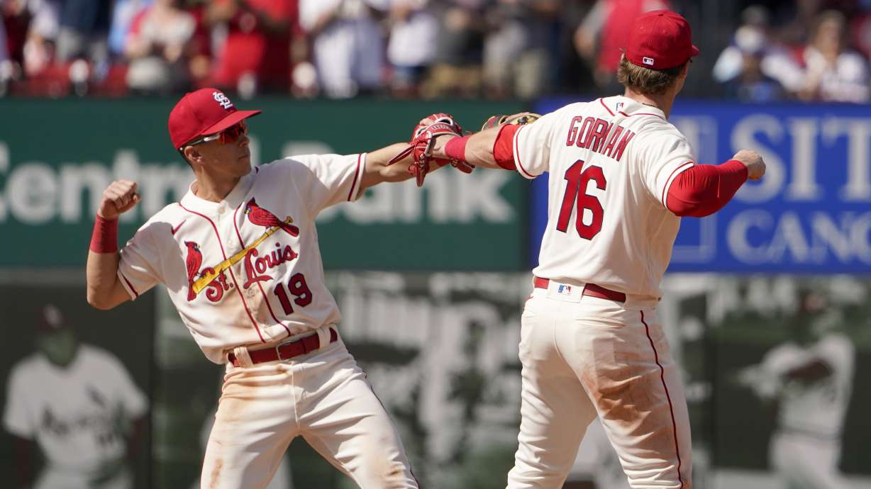 St. Louis Cardinals' Nolan Gorman (16) and Tommy Edman (19) celebrate an 8-3 victory over the Milwaukee Brewers in a baseball game Saturday, May 28, 2022, in St. Louis.