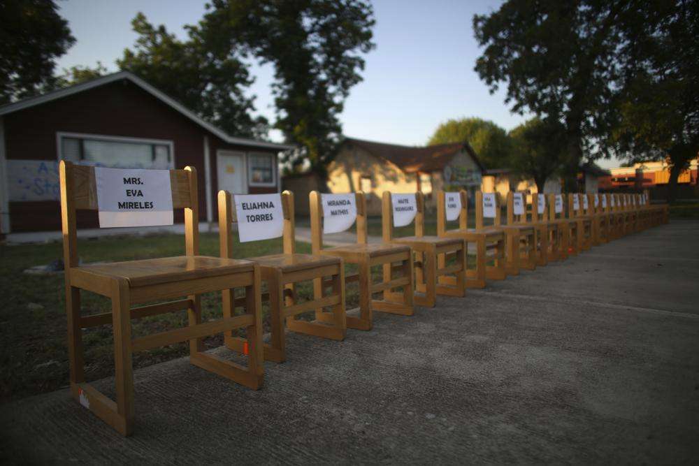 Twenty-one empty chairs are seen outside of a daycare center as a memorial for the victims killed earlier in the week in the elementary school shooting in Uvalde, Texas, Friday. Days after a local man burst into an elementary school and killed 19 children and two teachers before officers managed to kill him, the signs of grief, solidarity and local pride are everywhere in Uvalde, Texas.