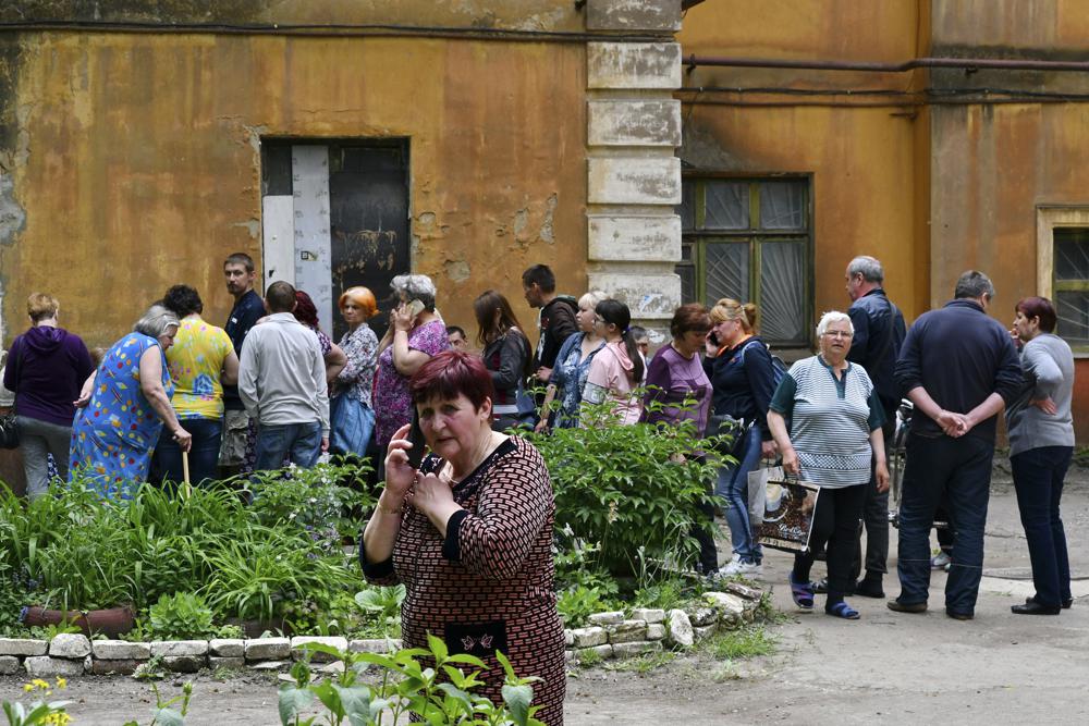 People wait to receive humanitarian aid in Kramatorsk, Ukraine, Saturday. After failing to occupy Ukraine's capital, Russia set out to seize the last parts of the eastern region not controlled by Kremlin-backed separatists.