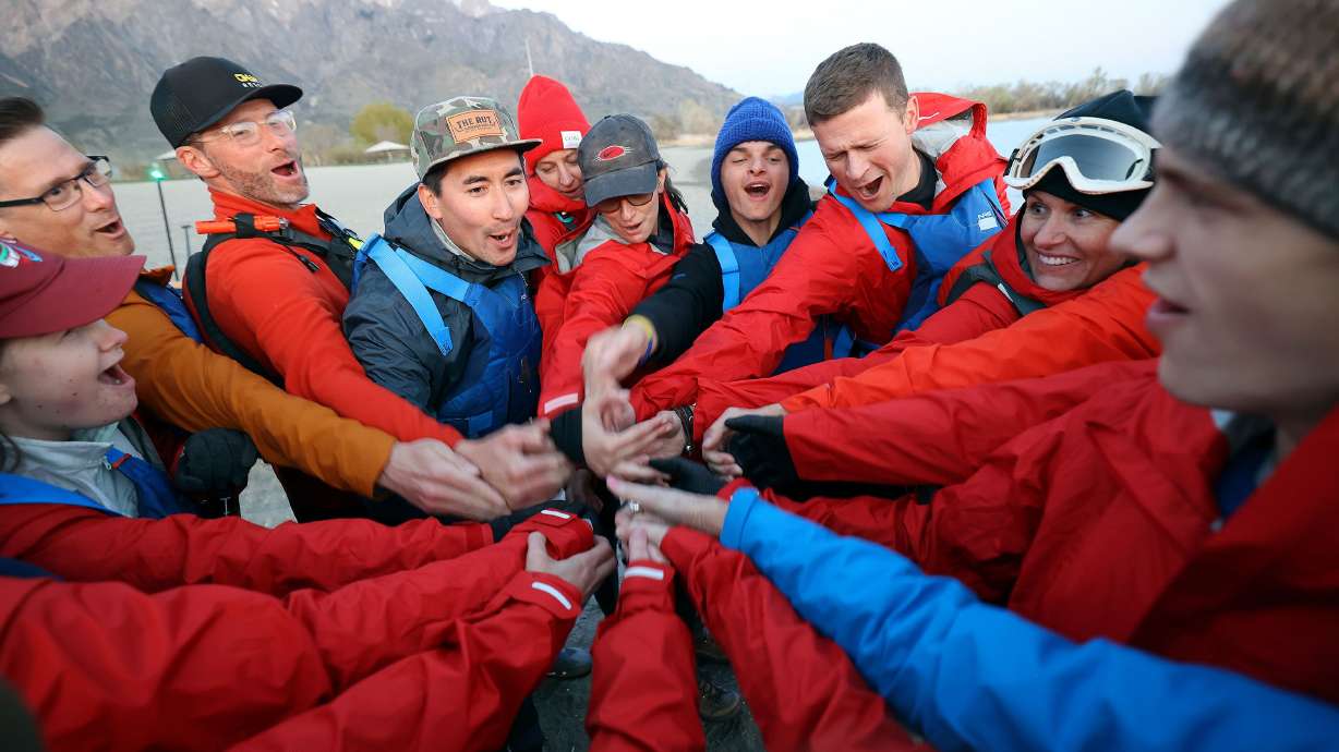 Ryan Greene, principal at the Utah Schools for the Deaf and the Blind, fourth from left, leads a group cheer at Pelican Beach at Willard Bay in Willard, Box Elder County, on April 29. Students and faculty from the USDB, and some support friends, are doing an overnight paddle mission to train for the SEVENTY48, an upcoming 70-mile boat race between Tacoma and Port Townsend, Wash., that has to be completed in 48 hours.