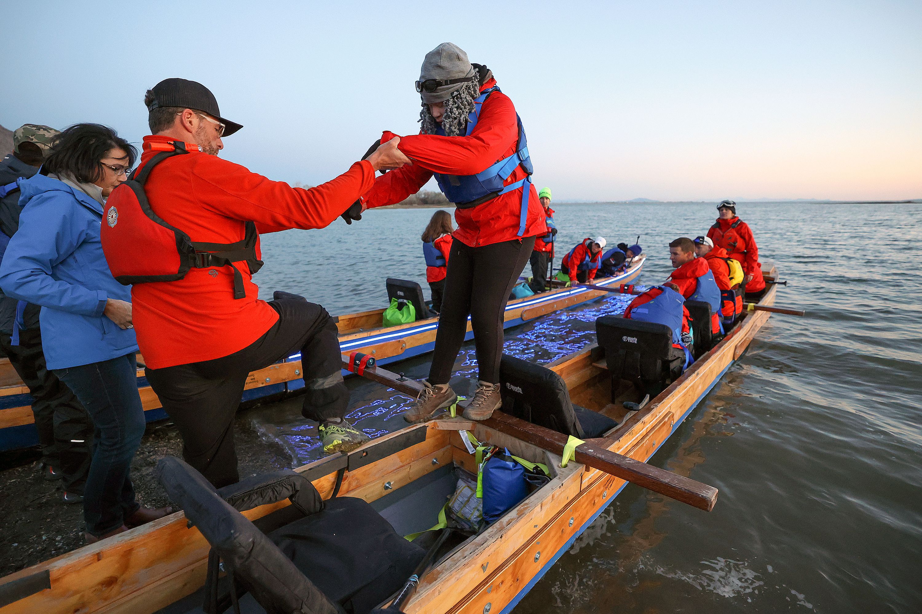 Darren Anderson, left, helps Erica Emery, a legally blind sophomore with oculocutaneous albinism, navigate her way off a boat at Pelican Beach at Willard Bay in Willard, Box Elder County on April 29. Students and faculty from the Utah Schools for the Deaf and the Blind, and some support friends, are doing an overnight paddle mission to train for the SEVENTY48, an upcoming 70-mile boat race between Tacoma and Port Townsend, Wash., that has to be completed in 48 hours.
