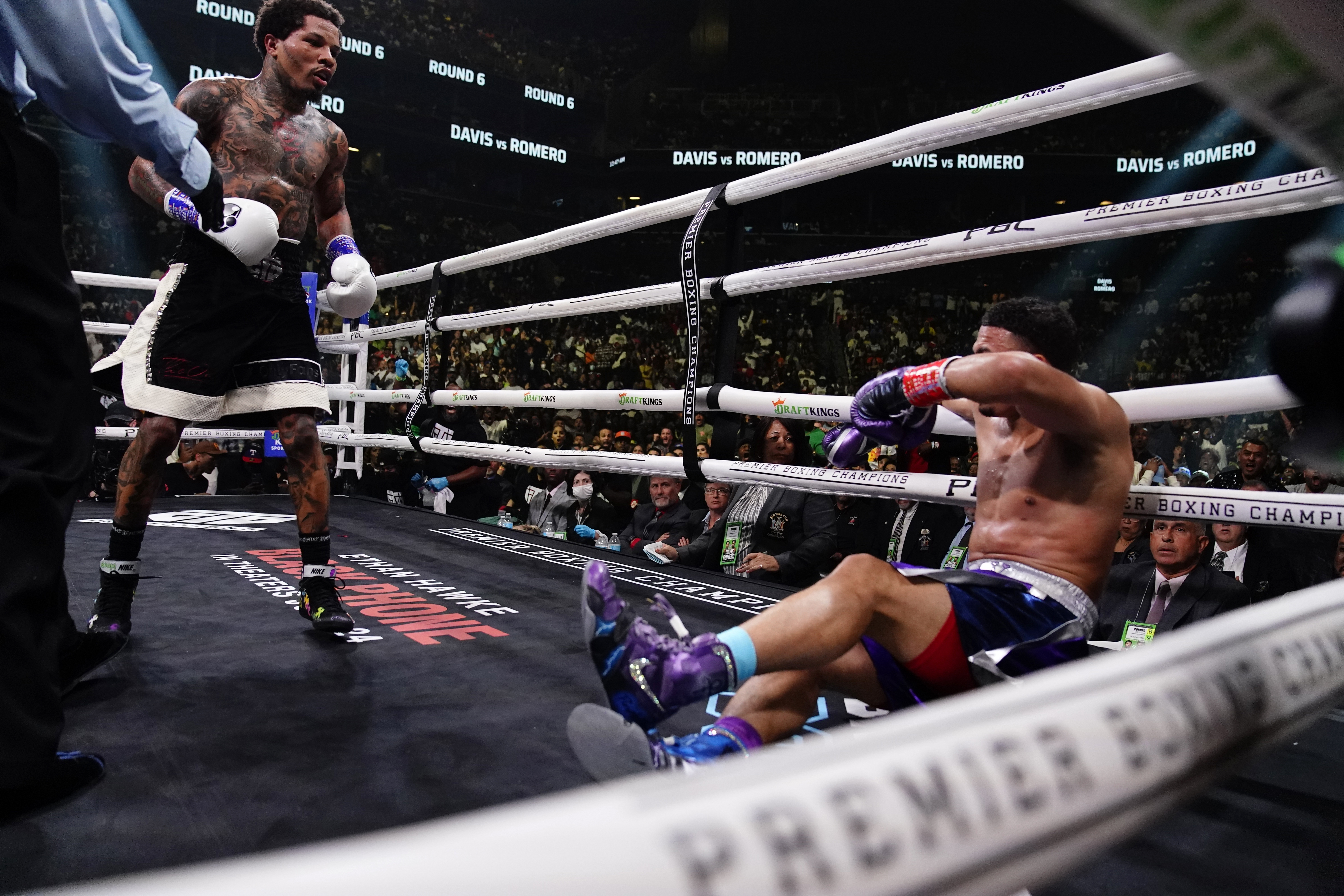 The referee restrains Gervonta Davis, left, after he knocked down Rolando Romero during the sixth round of a WBA lightweight championship boxing bout early Sunday, May 29, 2022, in New York. Davis won in the sixth round. 