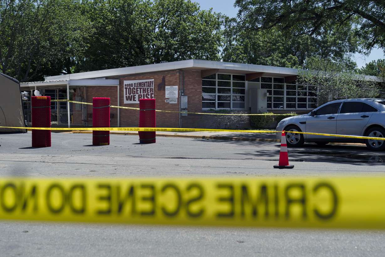 Crime scene tape surrounds Robb Elementary School after a mass shooting in Uvalde, Texas, Tuesday.