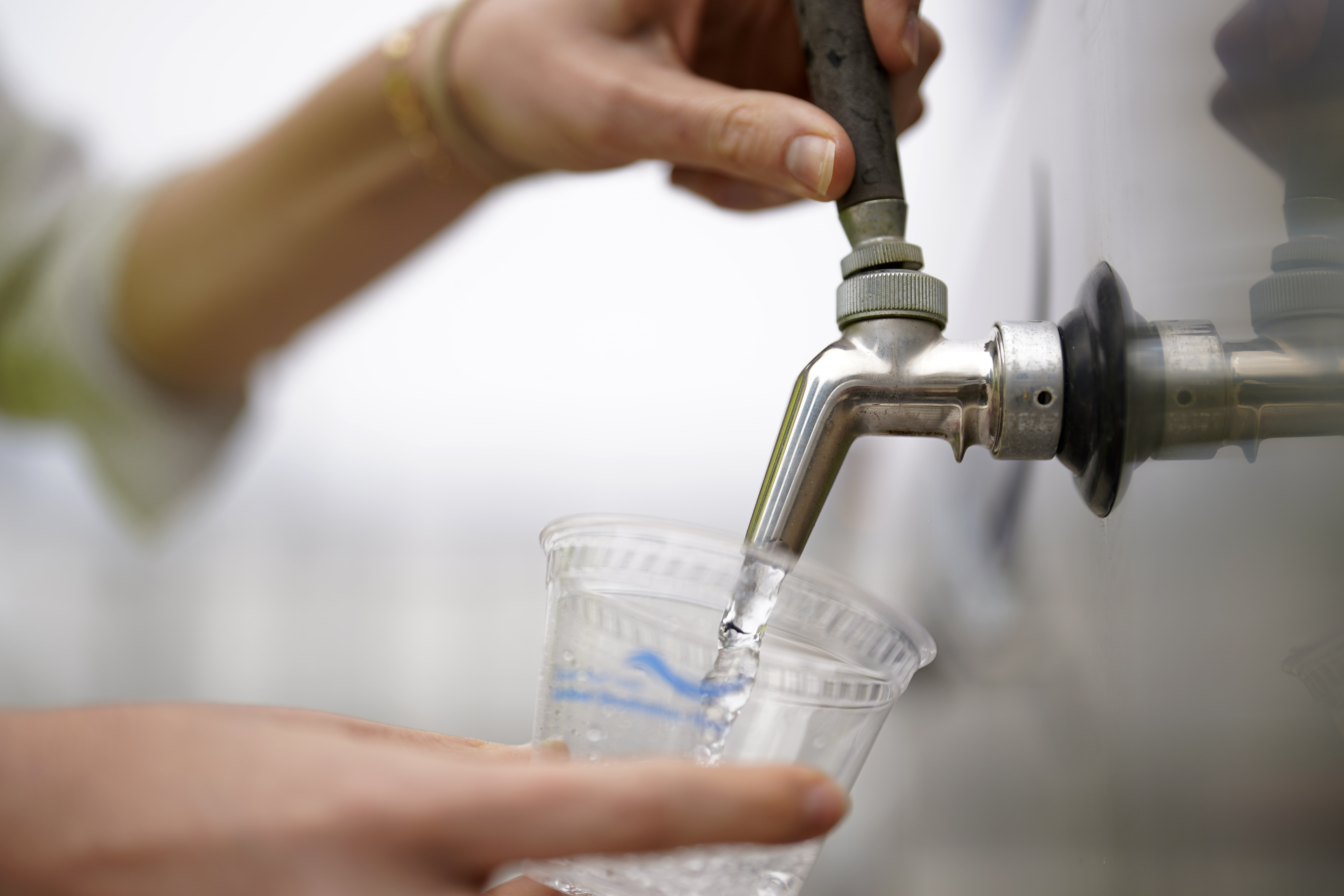 An official at the Carlsbad Desalination plant fills a cup with filtered water made from ocean water, Thursday, in Carlsbad, Calif. The facility is the Western hemisphere's largest desalination plant, which removes salt and impurities from ocean water.