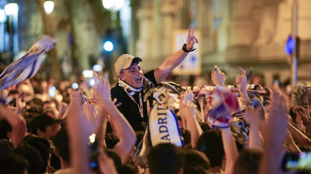 Real Madrid supporters celebrate at the end of the Champions League soccer final in Cibeles square in downtown Madrid, Spain, Sunday, May 29, 2022. Real Madrid beat Liverpool 1-0 in the Champions League final in Paris.