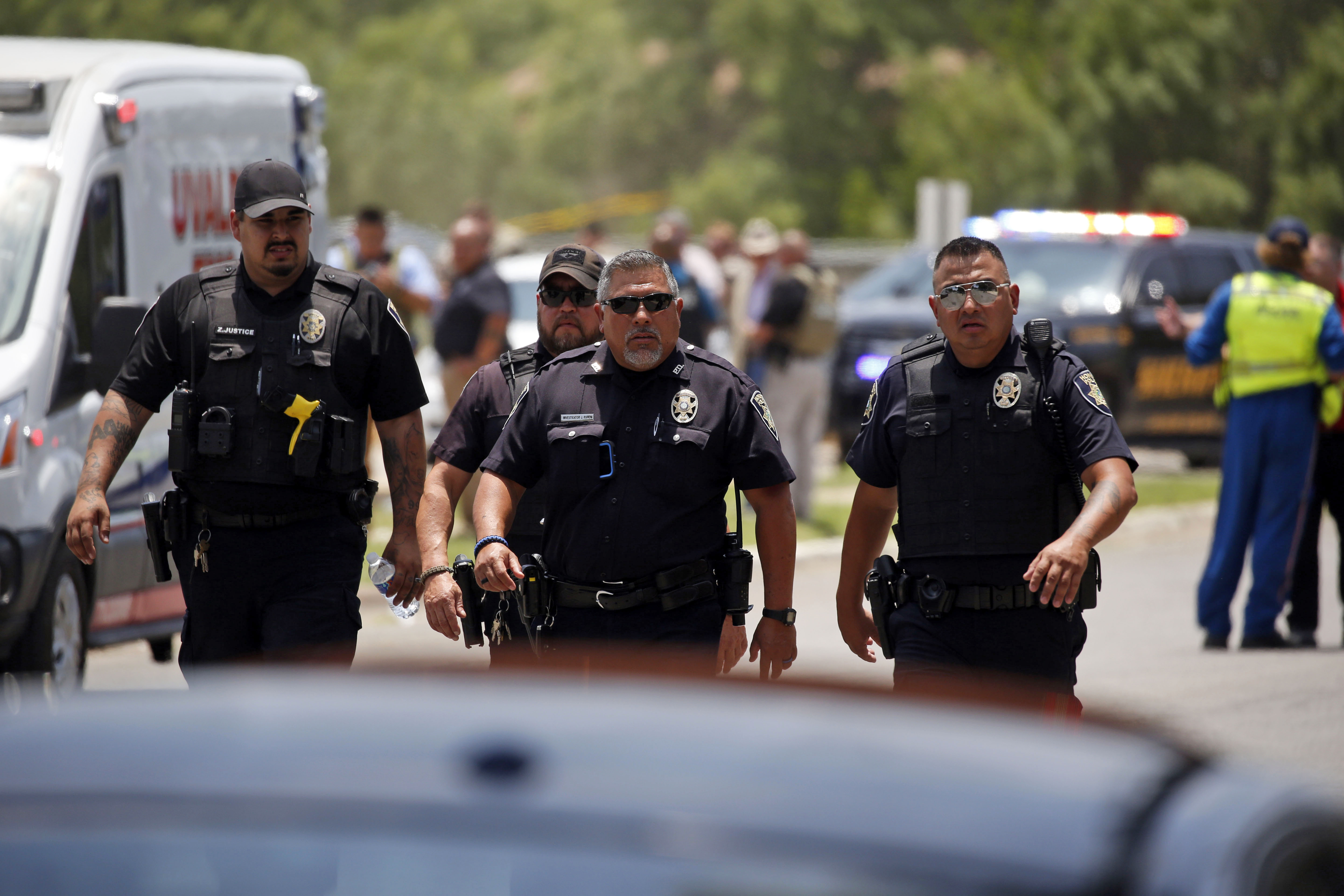 Police walk near Robb Elementary School following a shooting, Tuesday, in Uvalde, Texas. 