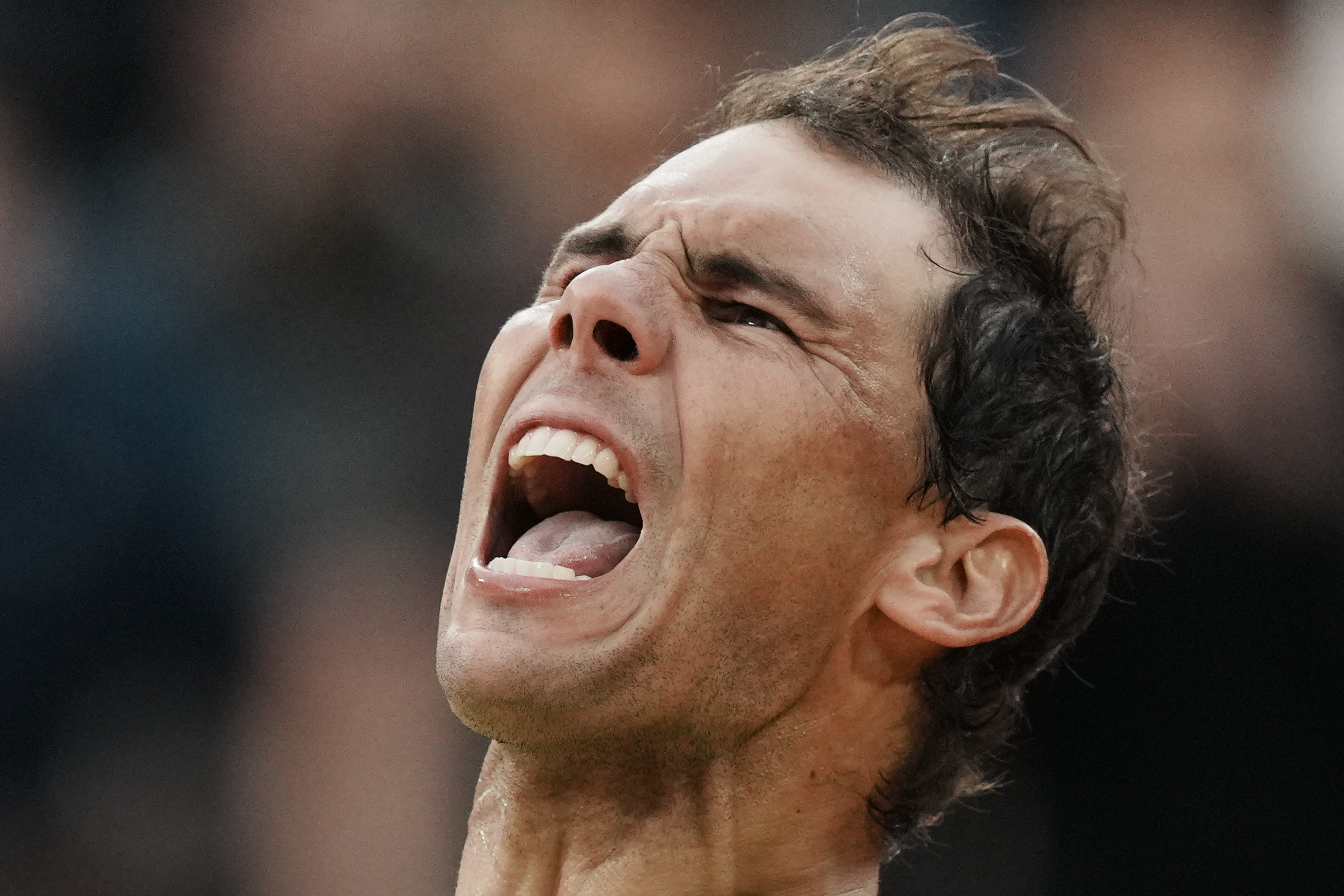 Spain's Rafael Nadal celebrates winning against Canada's Felix Auger-Aliassime in five sets, 3-6, 6-3, 6-2, 3-6, 6-3, during their fourth round match at the French Open tennis tournament in Roland Garros stadium in Paris, France, Sunday, May 29, 2022. 
