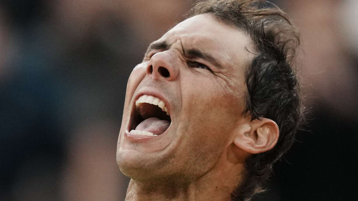 Spain's Rafael Nadal celebrates winning against Canada's Felix Auger-Aliassime in five sets, 3-6, 6-3, 6-2, 3-6, 6-3, during their fourth round match at the French Open tennis tournament in Roland Garros stadium in Paris, France, Sunday, May 29, 2022.
