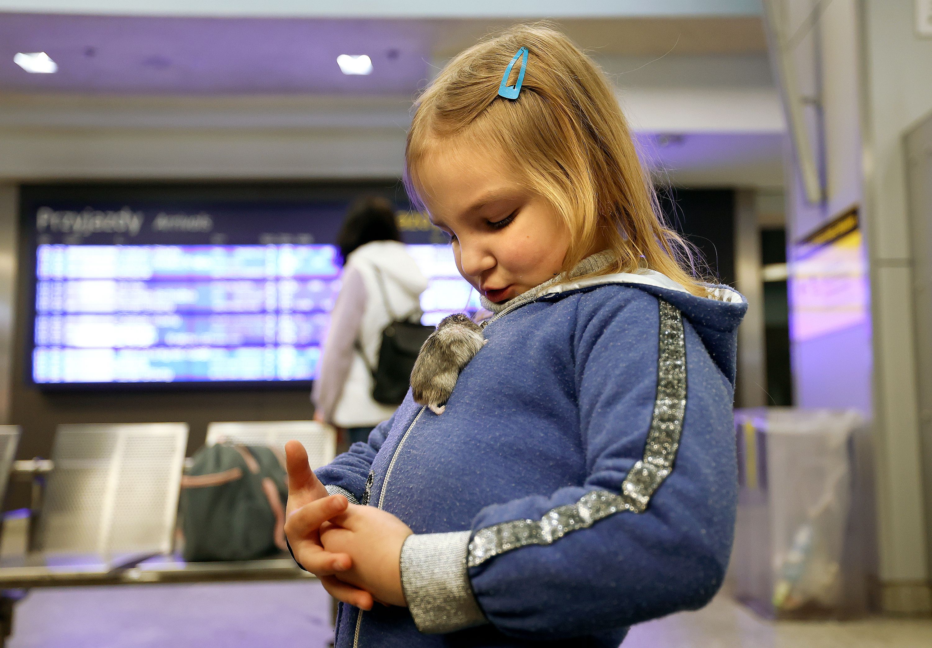 Ukrainian refugee Margarita Mishustina plays with her pet mouse Busya in the Krakow Glowny train station in Krakow, Poland, on April 16.