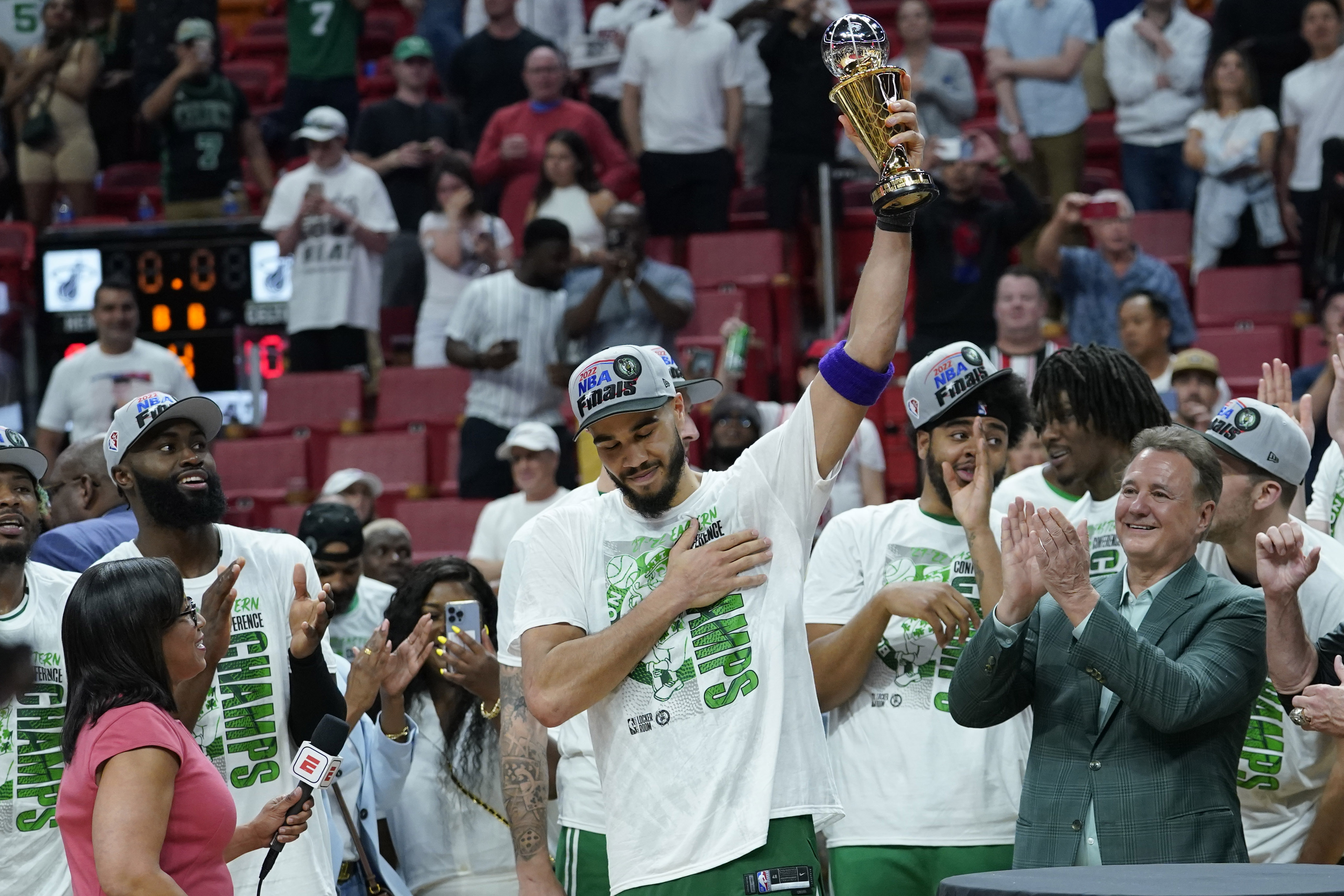 Boston Celtics forward Jayson Tatum raises the NBA Eastern Conference MVP trophy after defeating the Miami Heat in Game 7 of the NBA basketball Eastern Conference finals playoff series, Sunday, May 29, 2022, in Miami. 