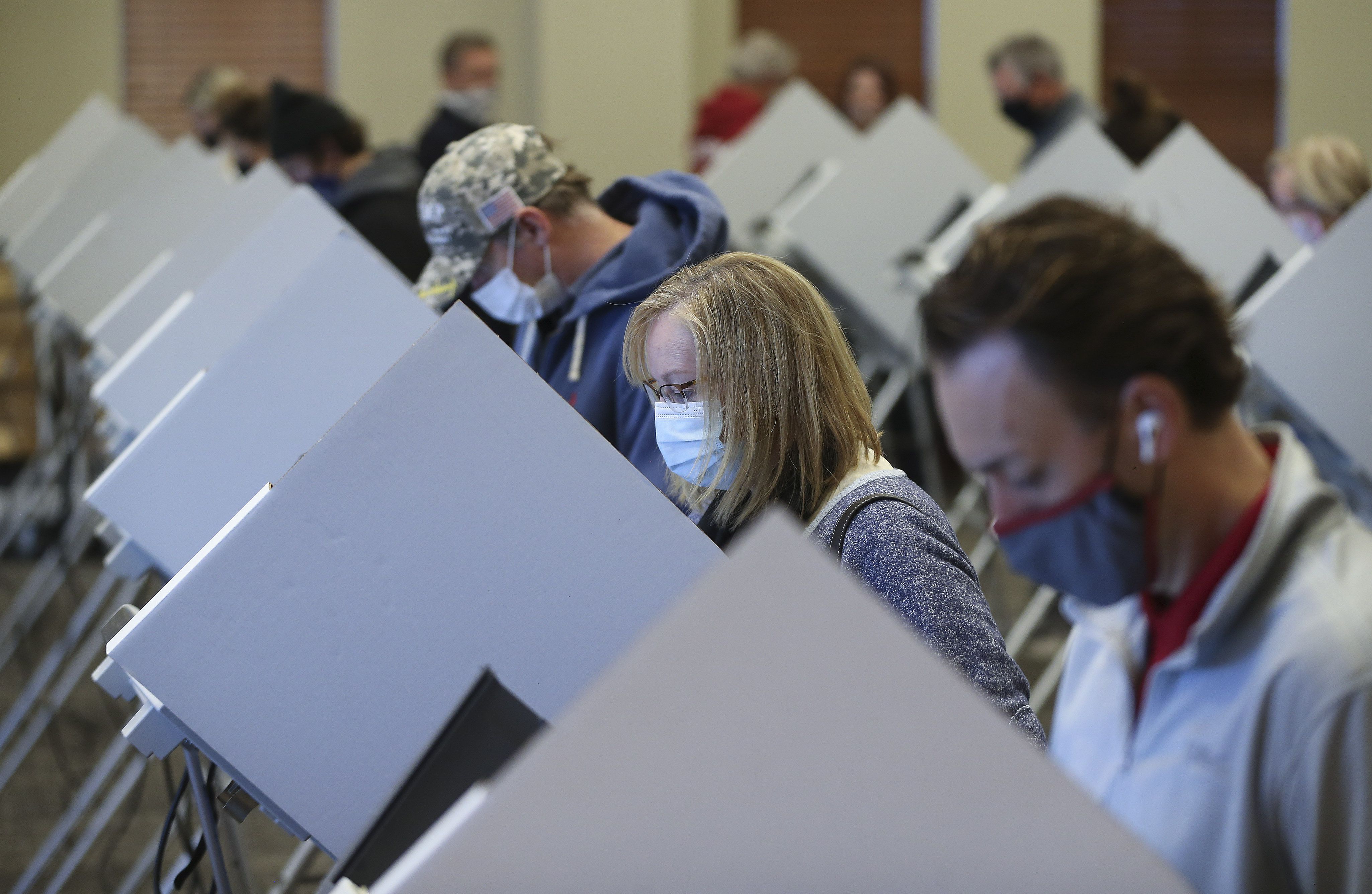 Jeanna Henderson, second from right, votes at Draper City Hall in Draper on Nov. 3, 2020. A recent poll sheds further light on what motivates voters and how that might shape future elections in Utah.