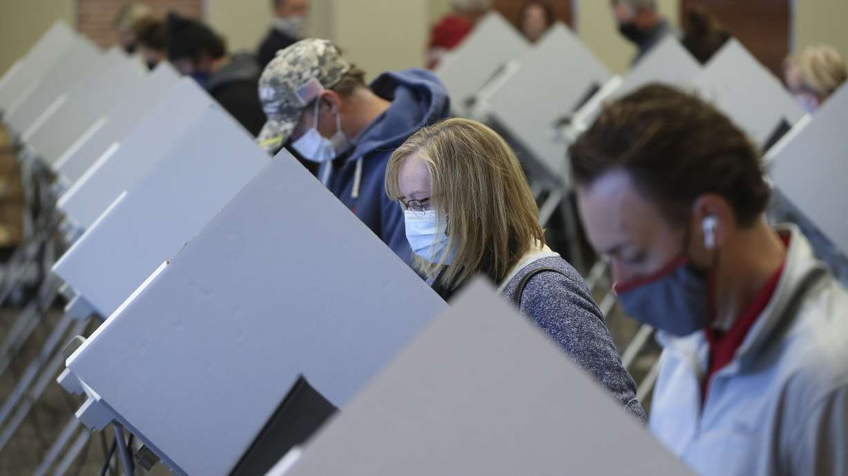 Jeanna Henderson, second from right, votes at Draper City Hall in Draper on Nov. 3, 2020. A recent poll sheds further light on what motivates voters and how that might shape future elections in Utah.