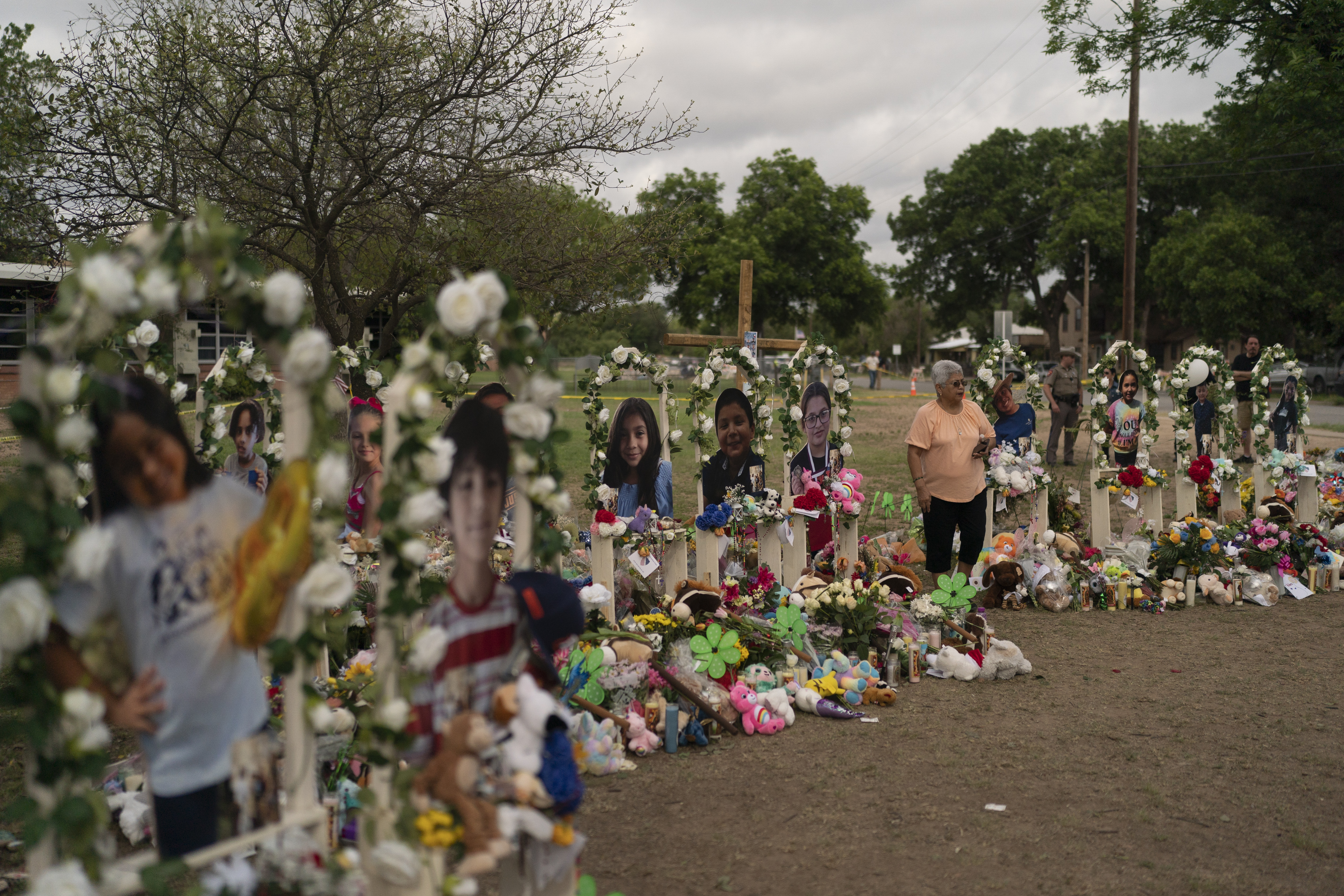 A woman visits a memorial at Robb Elementary School in Uvalde, Texas, Monday, to pay her respects to the victims killed in last week's school shooting.