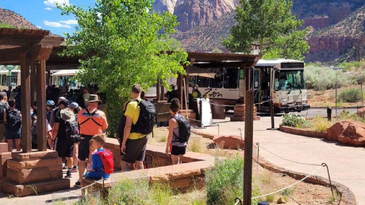 Long lines of people await the shuttles inside Zion National Park, June 3, 2021.