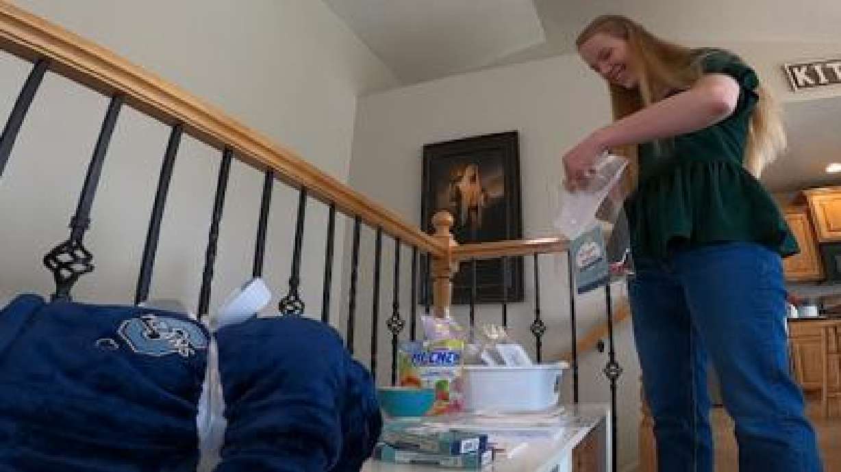 Hailey Barrett, a senior graduate of Syracuse High School, assembles crisis kits for the school's counseling center to hand out to students Monday.