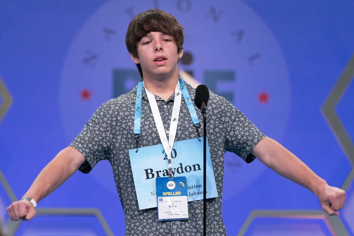 Braydon Syx, 13, stretches with relief on spelling a second word correctly, during the Scripps National Spelling Bee, in Oxon Hill, Md., Tuesday.