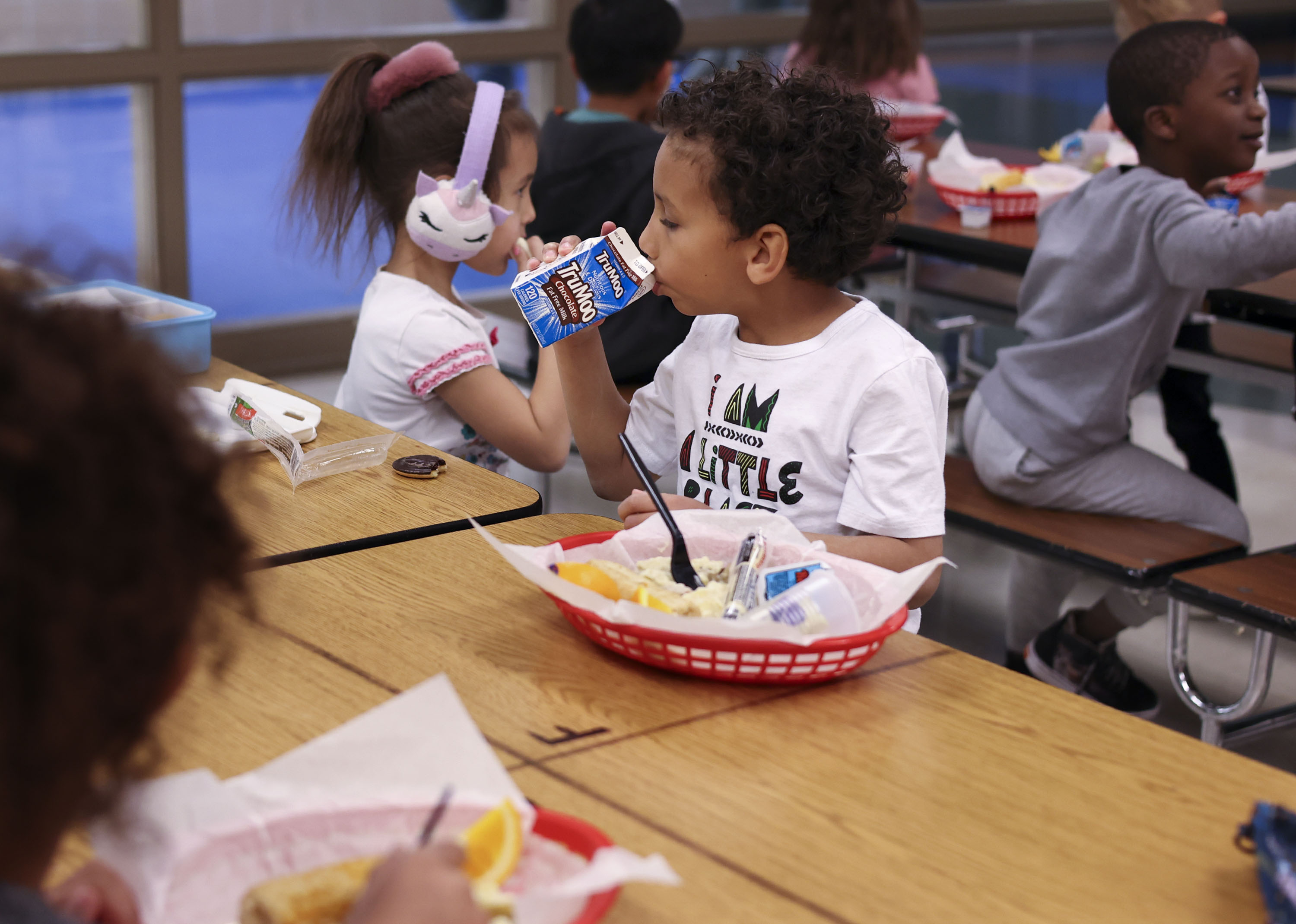 Kindergartner Gucci Carter eats lunch with his classmates at Woodrow Wilson Elementary School in Salt Lake City on Feb. 25. Students in many Utah school districts will have the option to access meals provided by their schools over the summer months.