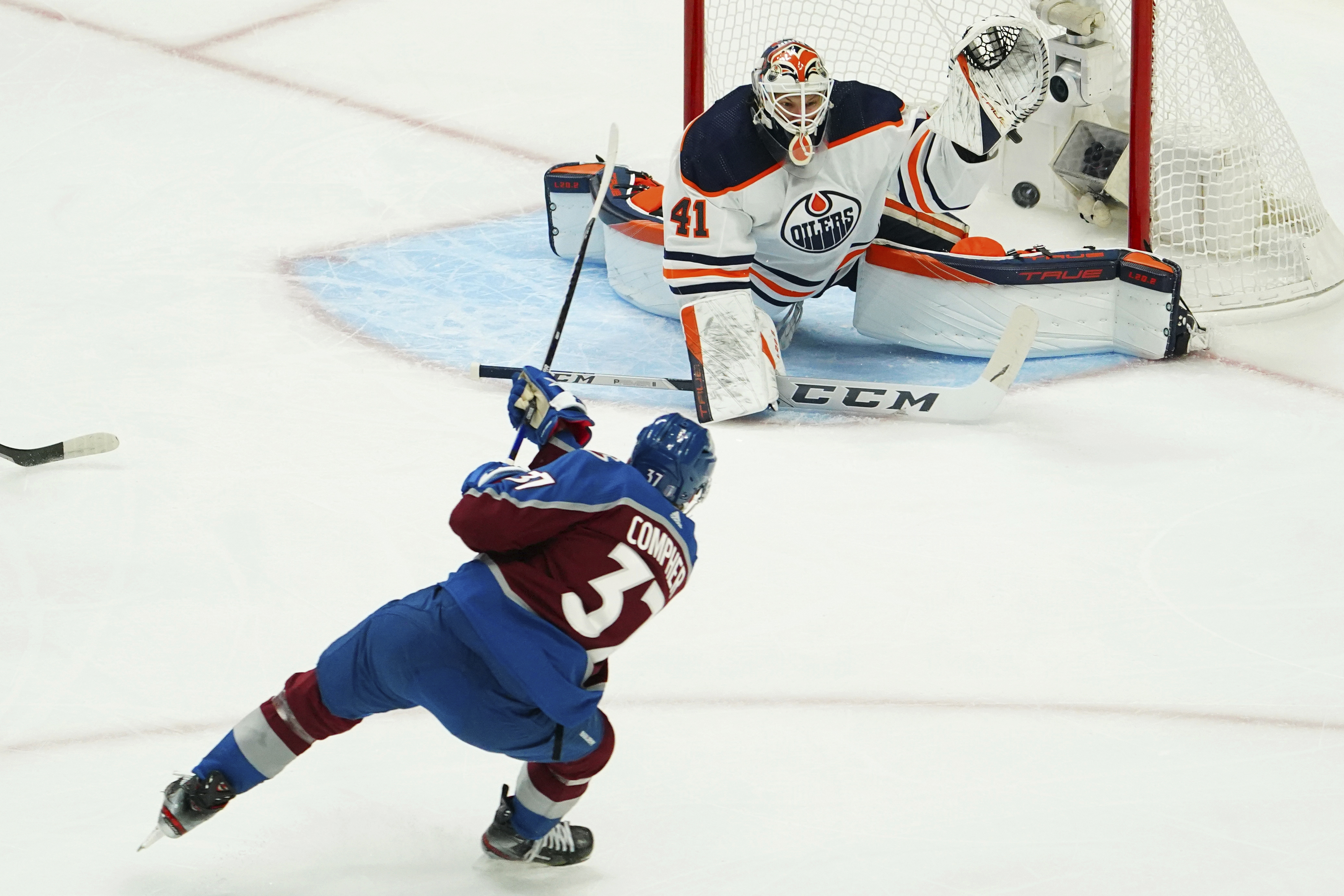 Colorado Avalanche left wing J.T. Compher (37) scores a goal against Edmonton Oilers goaltender Mike Smith (41) during the first period in Game 1 of the NHL hockey Stanley Cup playoffs Western Conference finals Tuesday, May 31, 2022, in Denver. 
