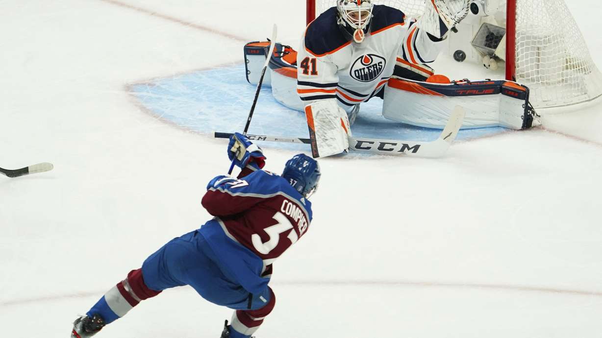 Colorado Avalanche left wing J.T. Compher (37) scores a goal against Edmonton Oilers goaltender Mike Smith (41) during the first period in Game 1 of the NHL hockey Stanley Cup playoffs Western Conference finals Tuesday, May 31, 2022, in Denver.